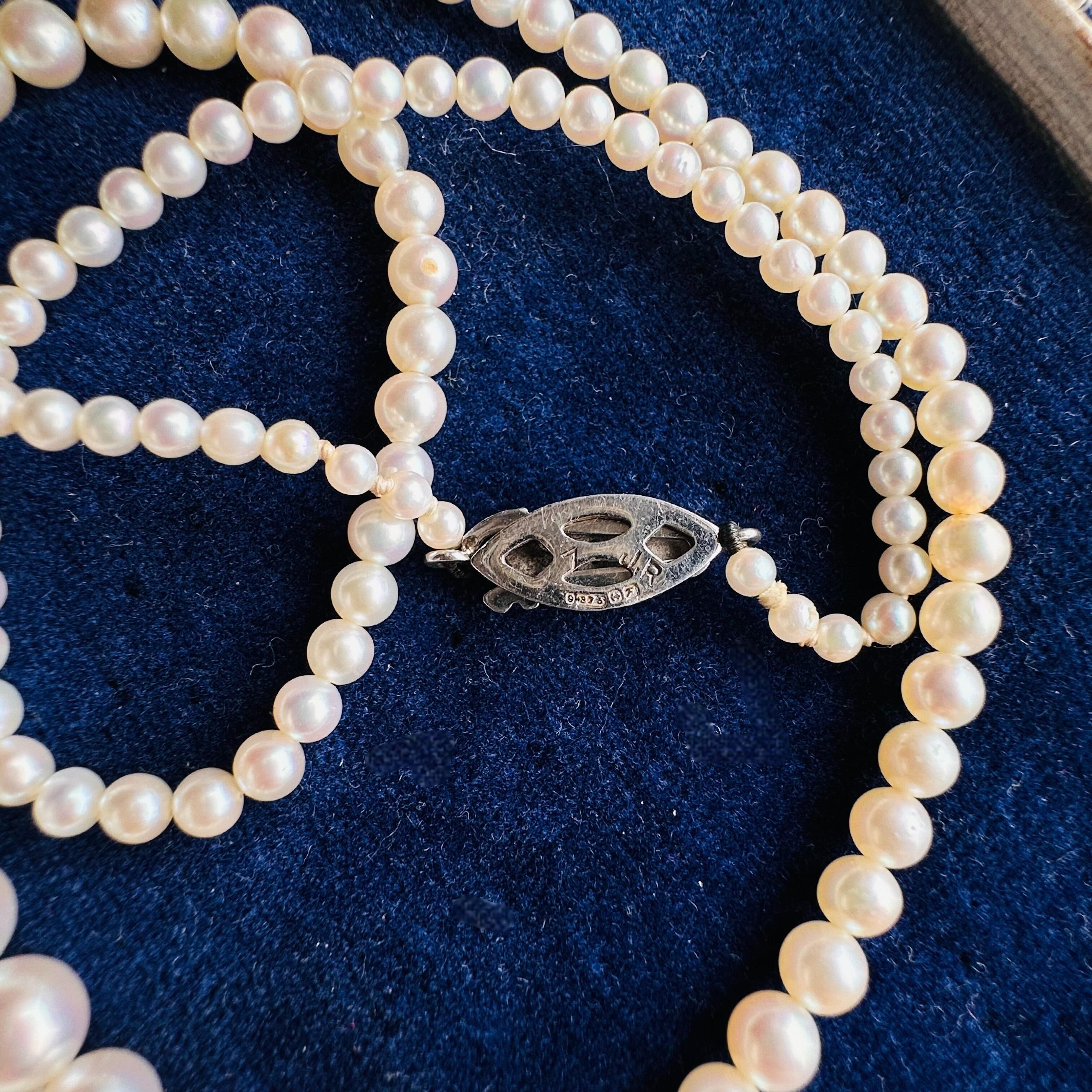 White Gold & Diamond, Saltwater Cultured Pearl Necklace displayed on antique box