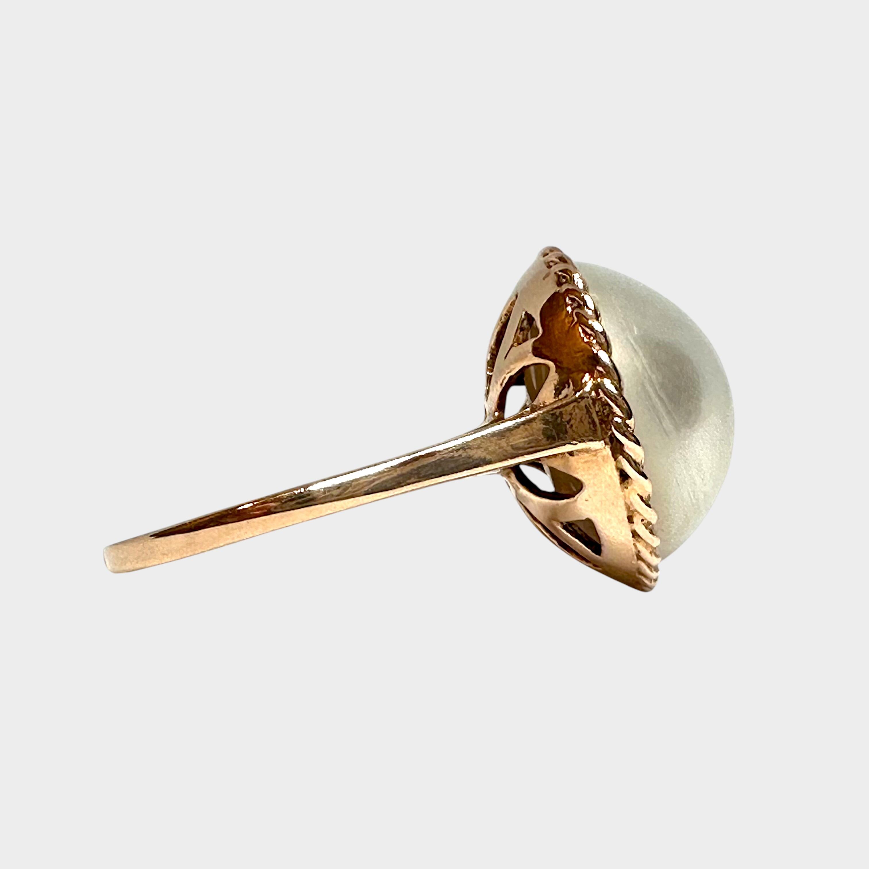 side profile of Vintage 9k Gold Mabe Pearl Cocktail Ring with grey background