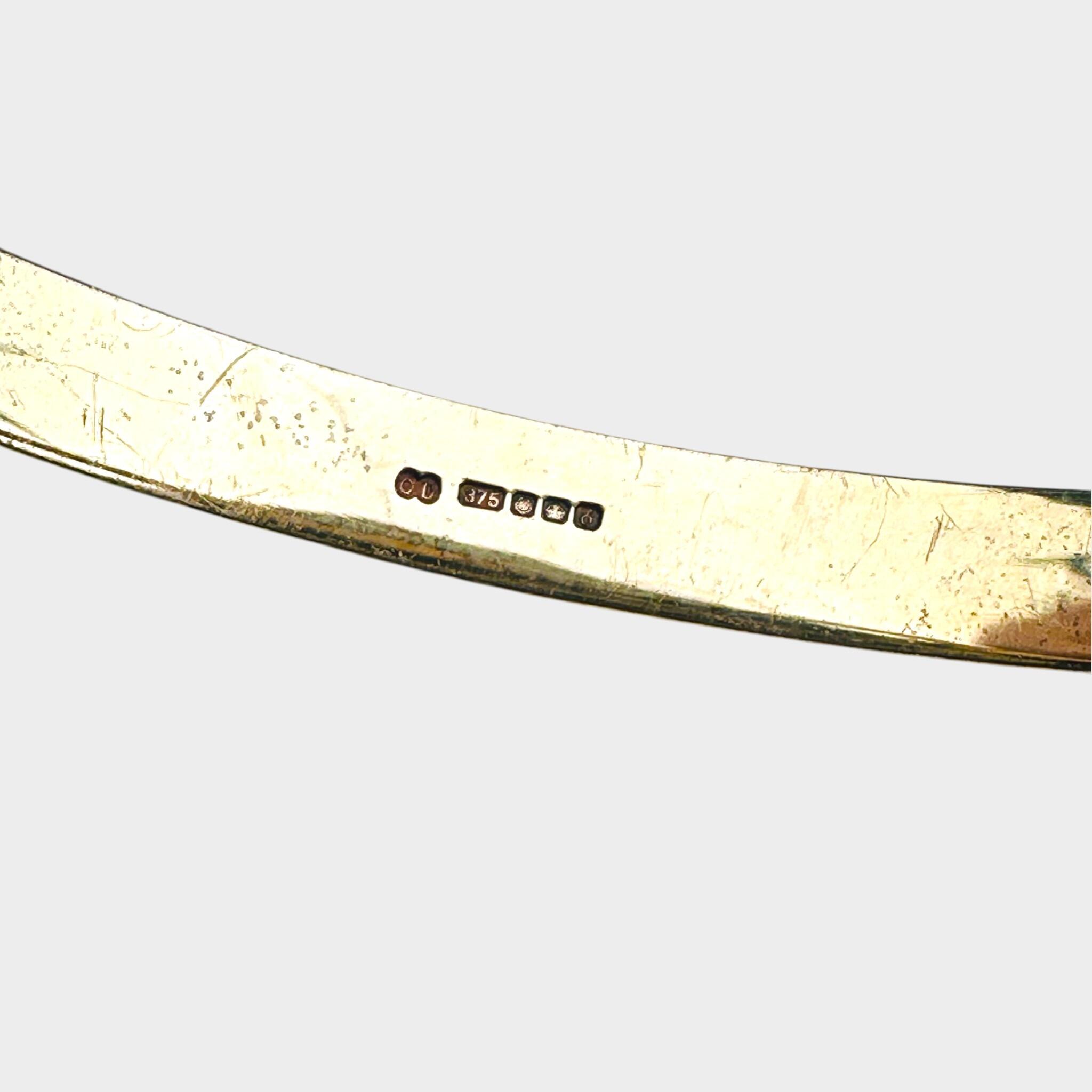 close up of hallmark of Vintage Two Tone Gold Bangle Bracelet with grey background
