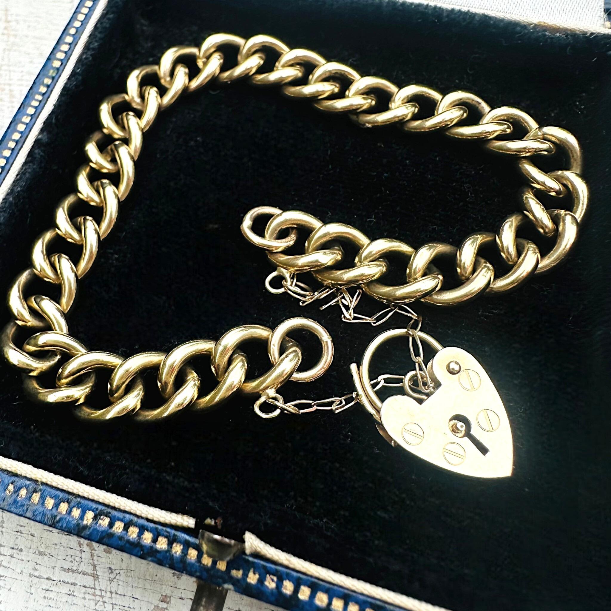 Heavy, Chunky Gold Curb Bracelet & Heart Padlock displayed on antique box