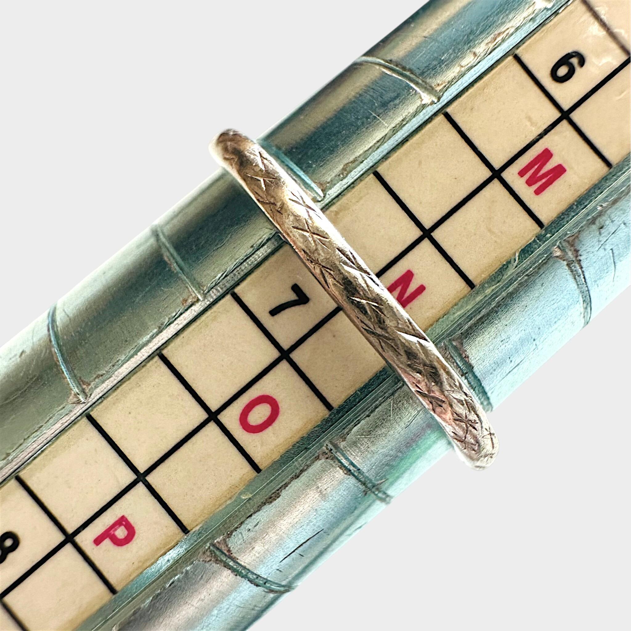 Art Deco Hand Engraved Platinum Wedding Band displayed on ring sizer