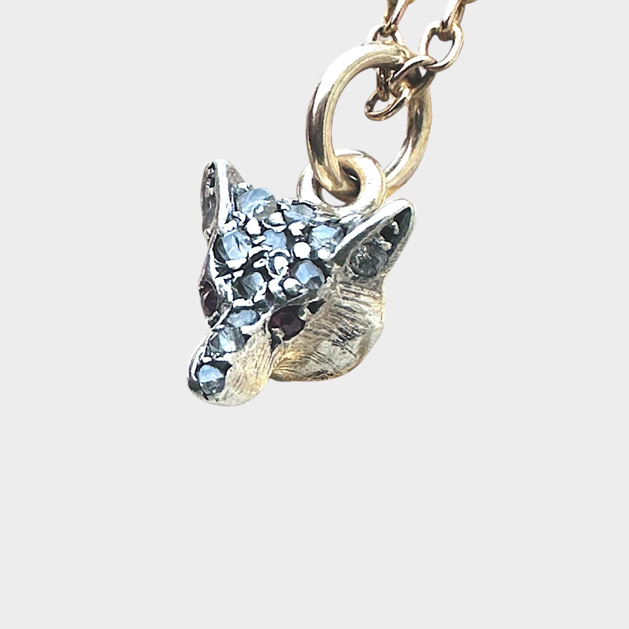 side view of Victorian Diamond & Ruby Eyes Fox Pendant with grey background