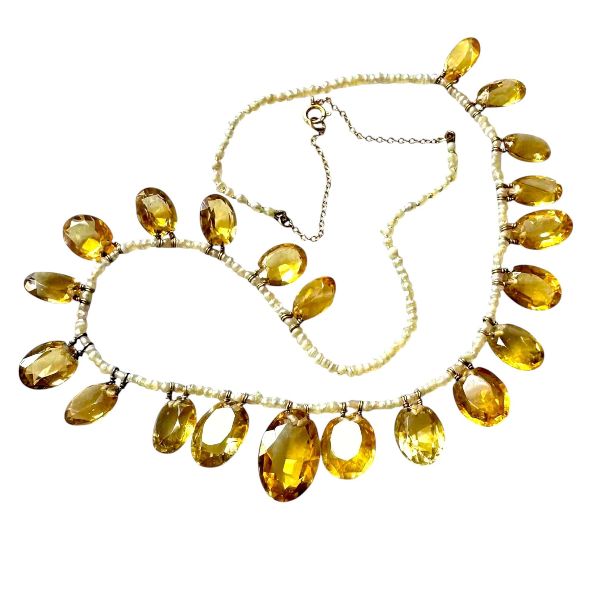 Edwardian citrine and pearl fringe necklace with 9ct gold chain, circa 1901 on white background