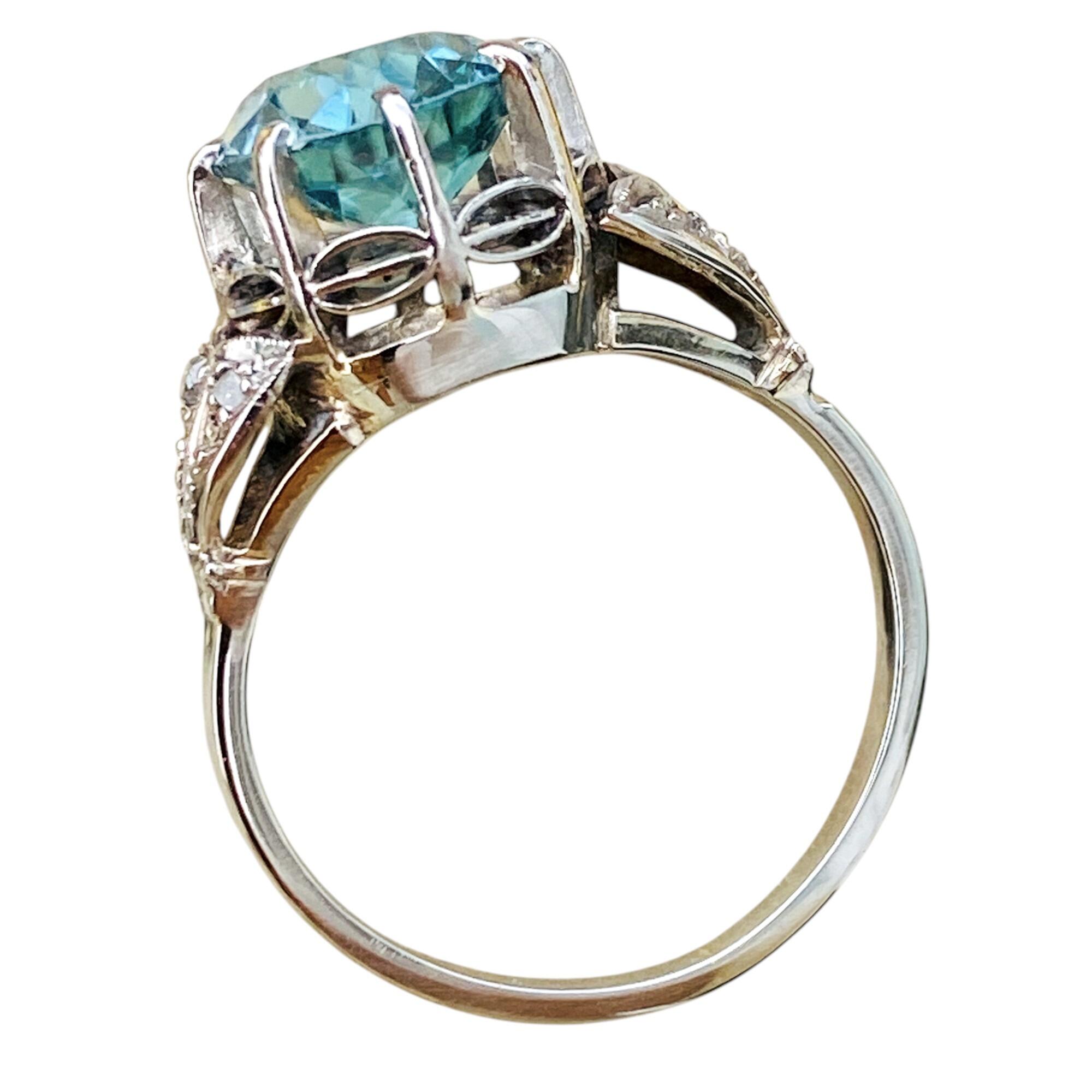 SIDE VIEW OF white gold ring with large blue zircon gemstone and diamond studded shoulders