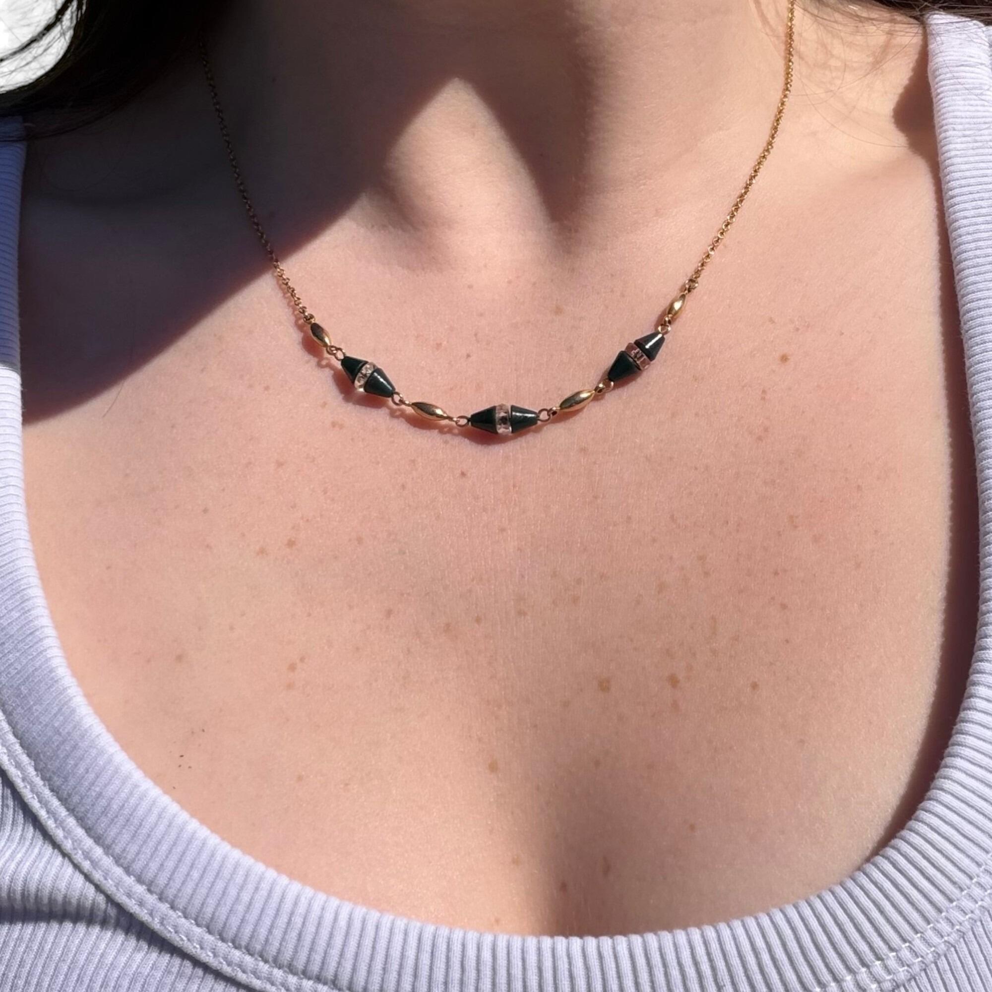 Antique Art Deco 9k Gold Bloodstone & Rock Crystal Bead Chain displayed on models neck .