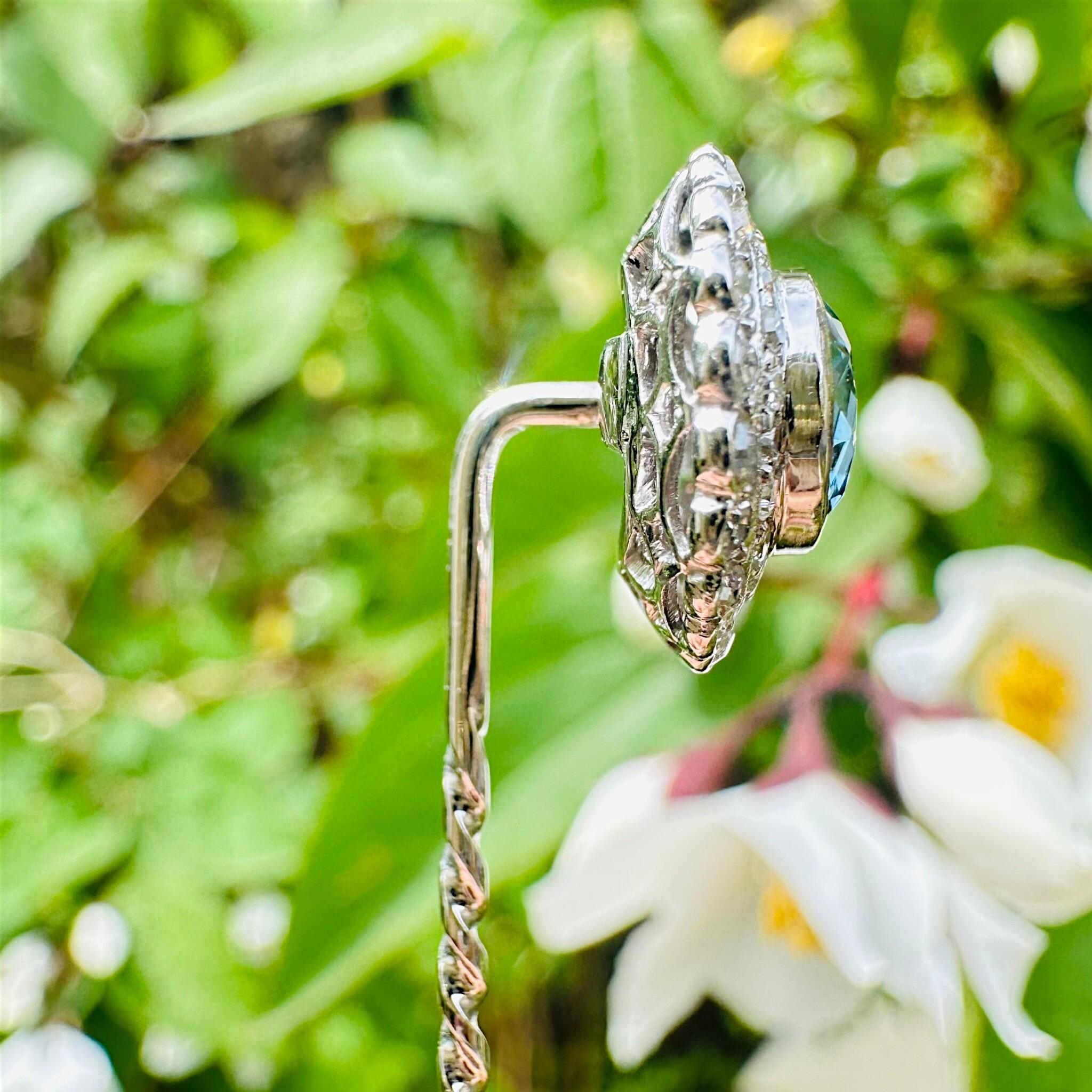 side profile of Antique Art Deco Platinum Blue Zircon & Diamond Stick Pin displayed in garden