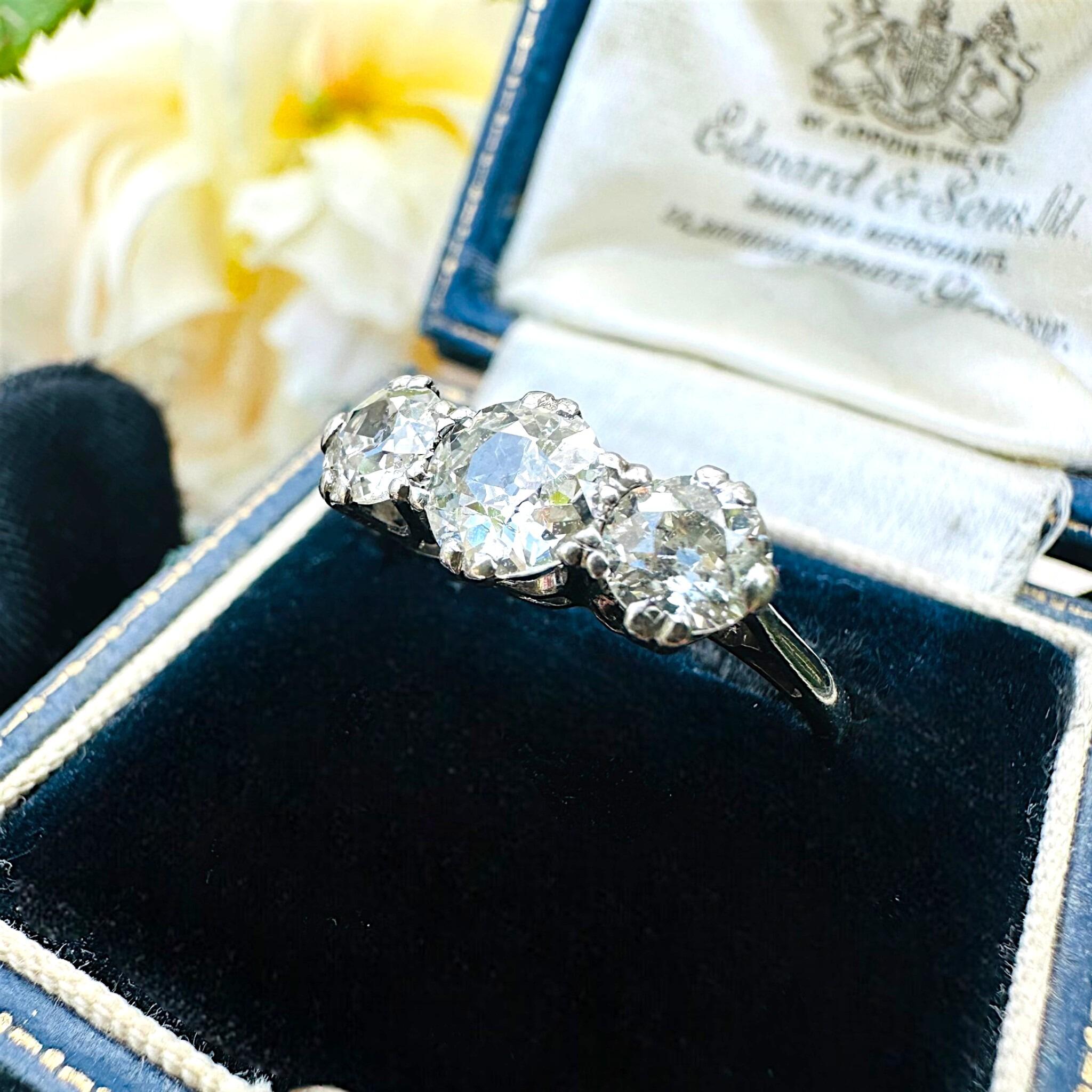 side profile of Antique Art Deco18K White Gold & Platinum, Old European Cut Diamond Trilogy Ring displayed in antique box