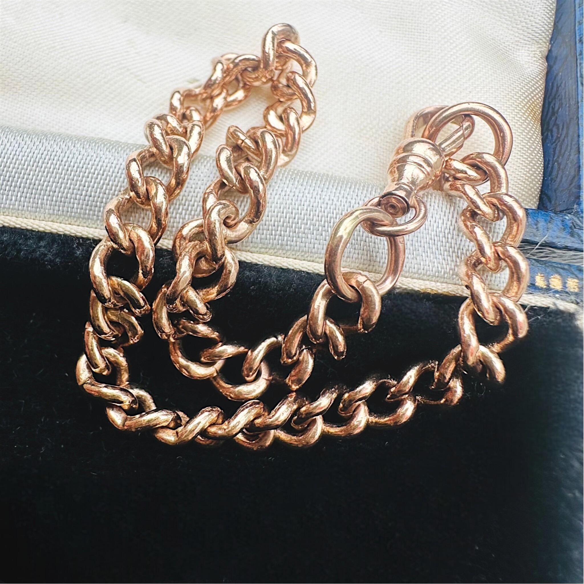 Antique Rose Gold Curb Link & Dog Clip Bracelet laying on antique box