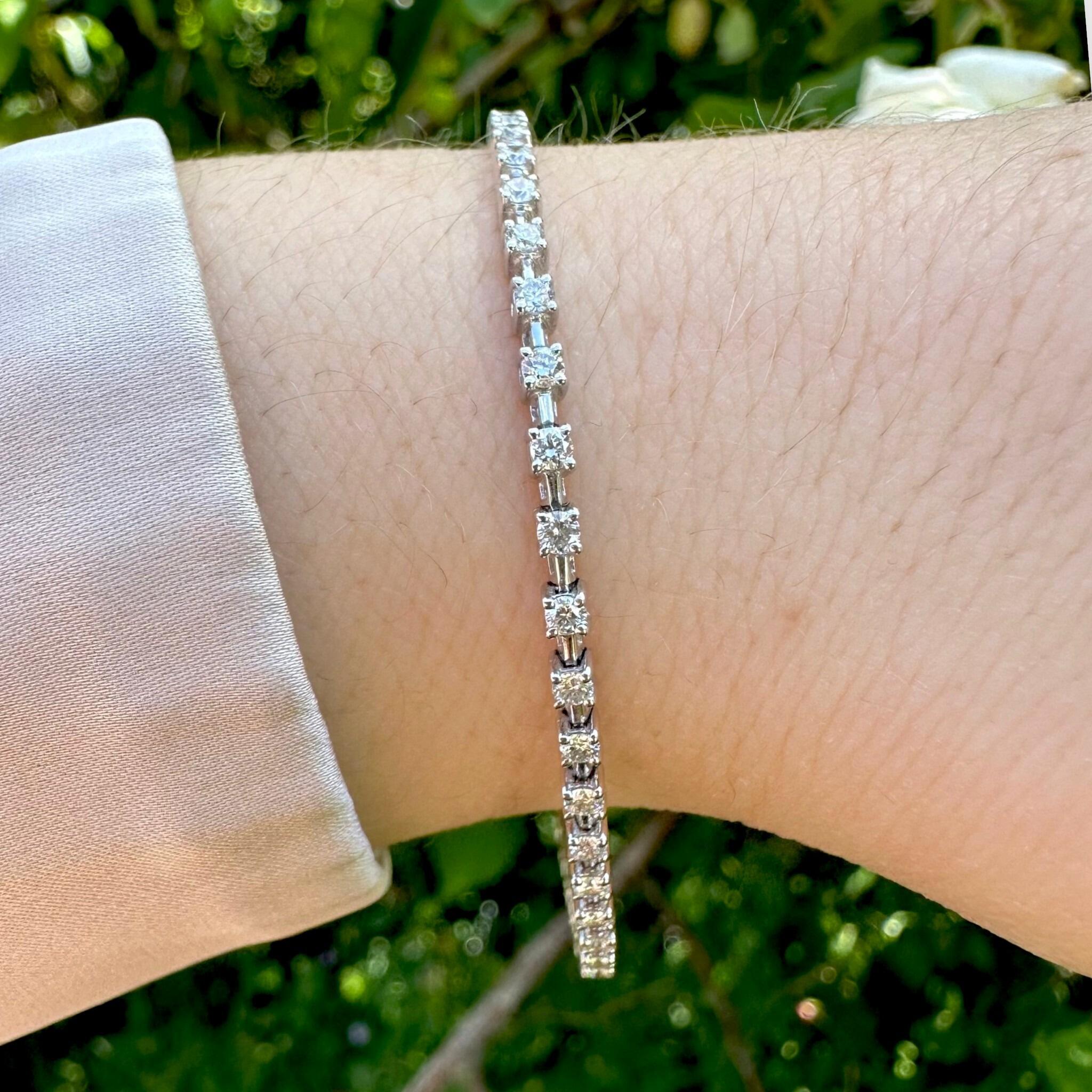 18K White Gold Diamond Tennis Bracelet displayed on models wrist in garden