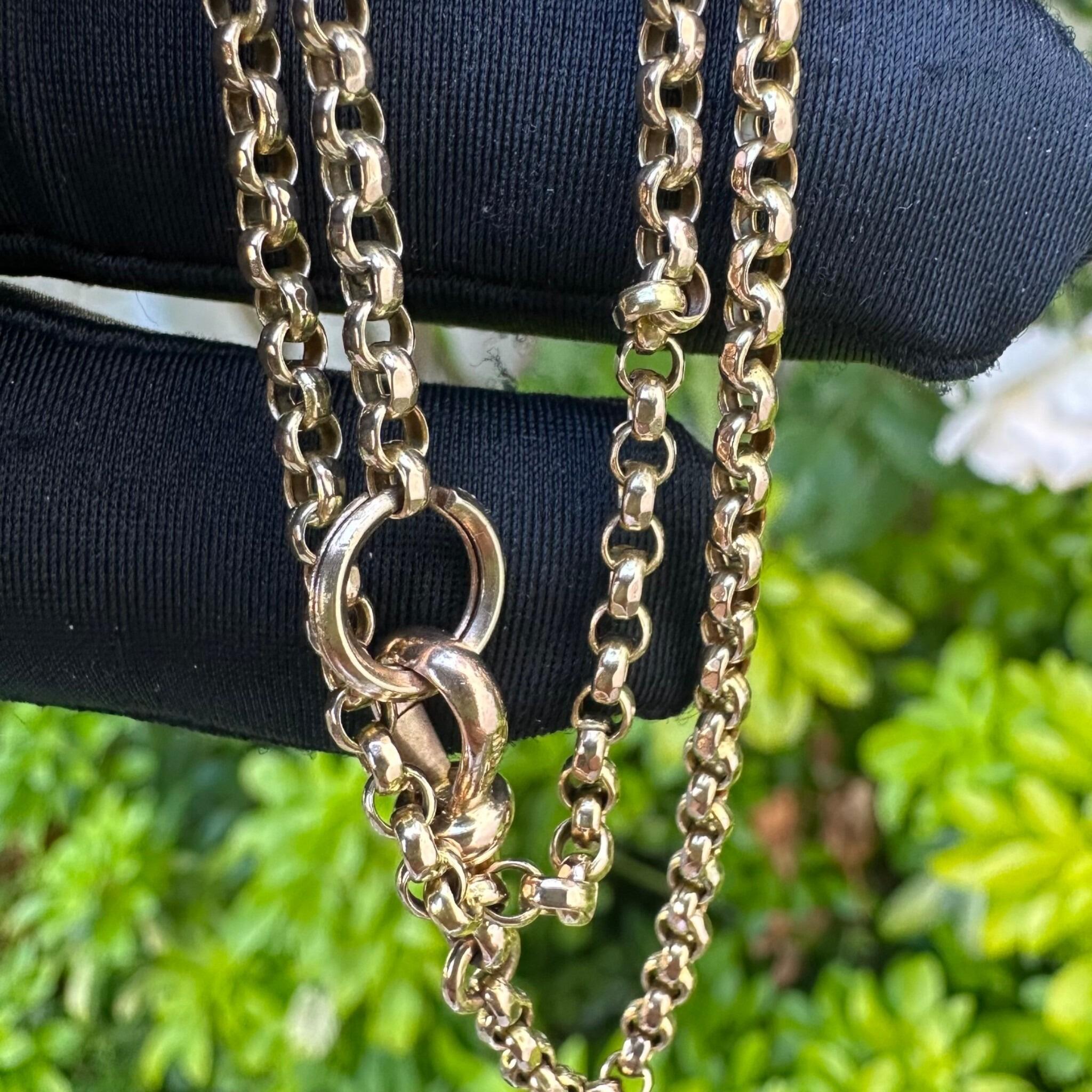 Antique Victorian 9ct Rose Gold Belcher Chain With Dog Clip & Split Ring clasp held in gloved hand in garden