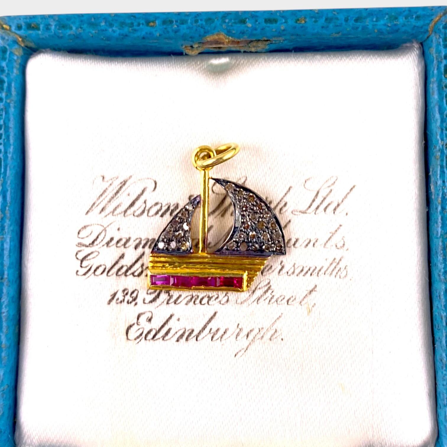 Vintage Diamond & Red Spinel Yacht Pendant Charm displayed on antique box