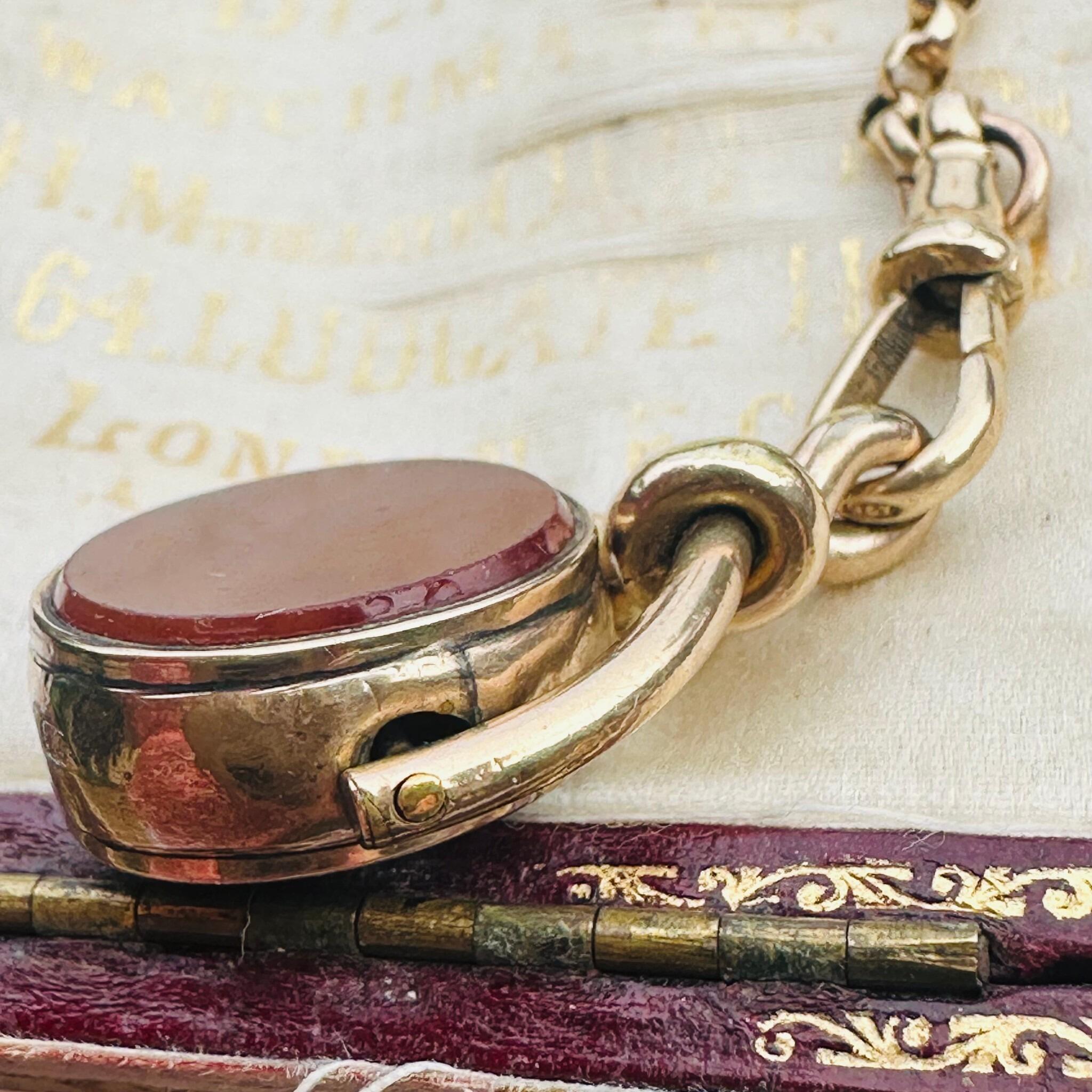 Antique Victorian 9ct Gold Bloodstone & Carnelian Swivel Fob displayed on antique box