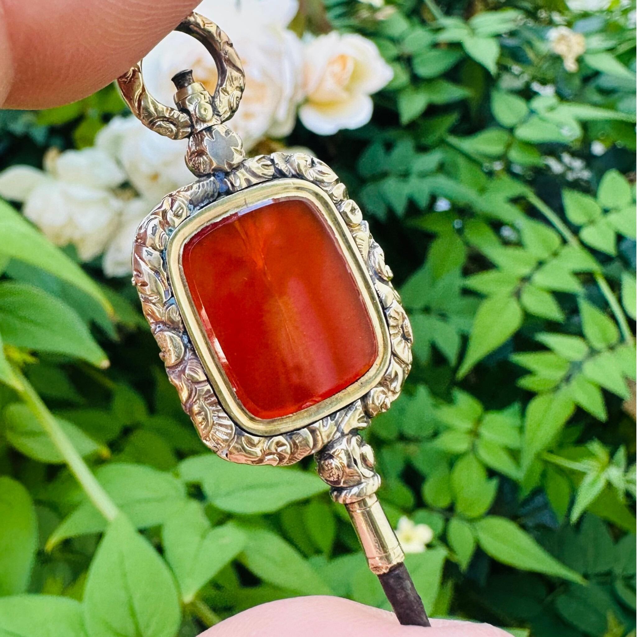 Antique Georgian Carnelian Watch Key Pendant held in garden