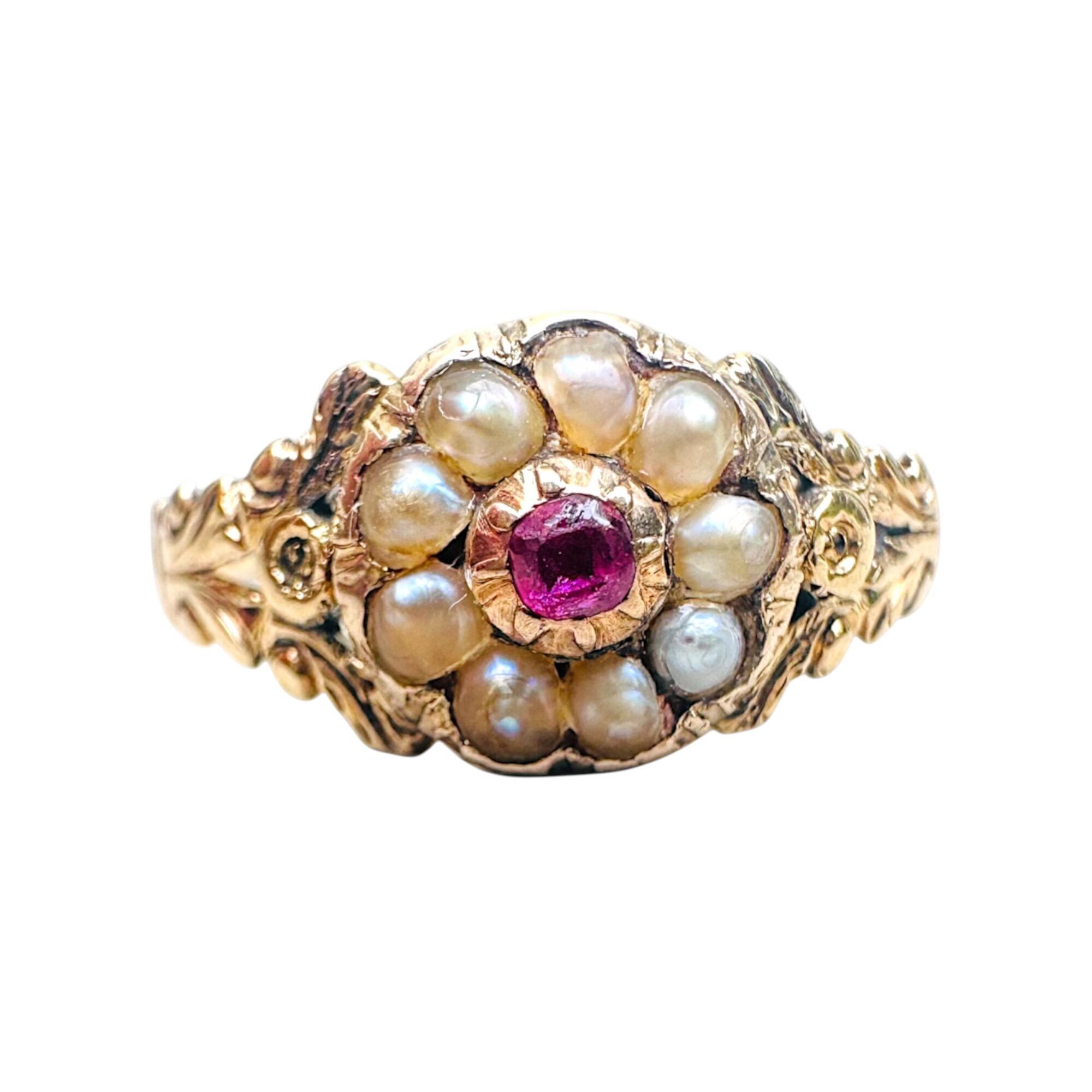 Front view of antique 15k gold Victorian ruby and pearl promise ring on grey background.