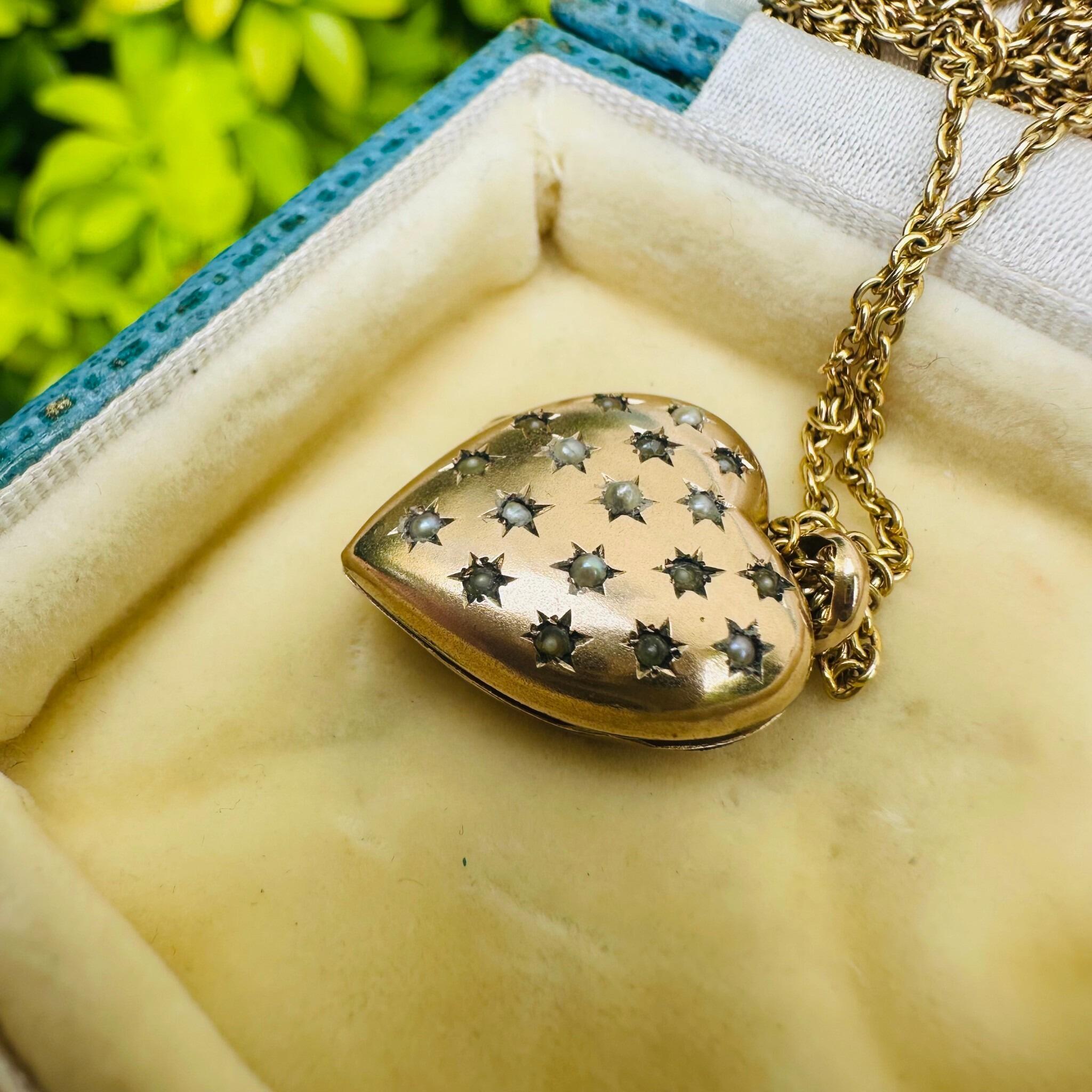 side profile of Vintage Gold Pearl Star Set Puffy Heart Locket displayed on antique box