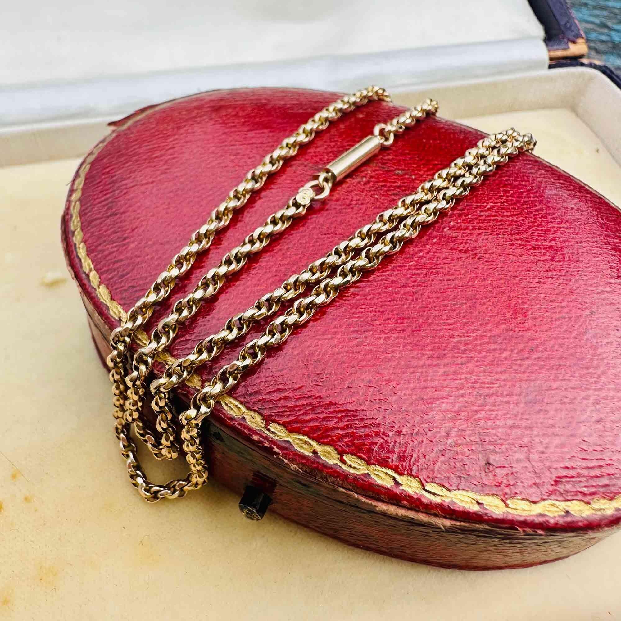 Antique 9ct gold rope chain necklace with classic barrel clasp, displayed on red antique box.