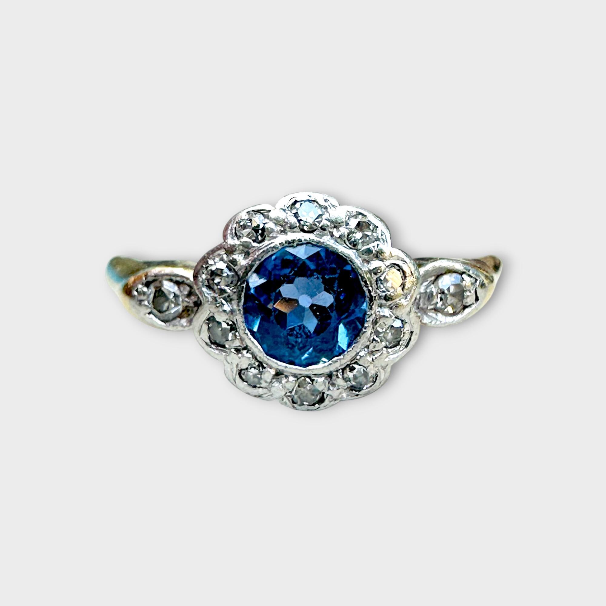 Front view of antique 18k gold sapphire and diamond daisy cluster ring with platinum setting