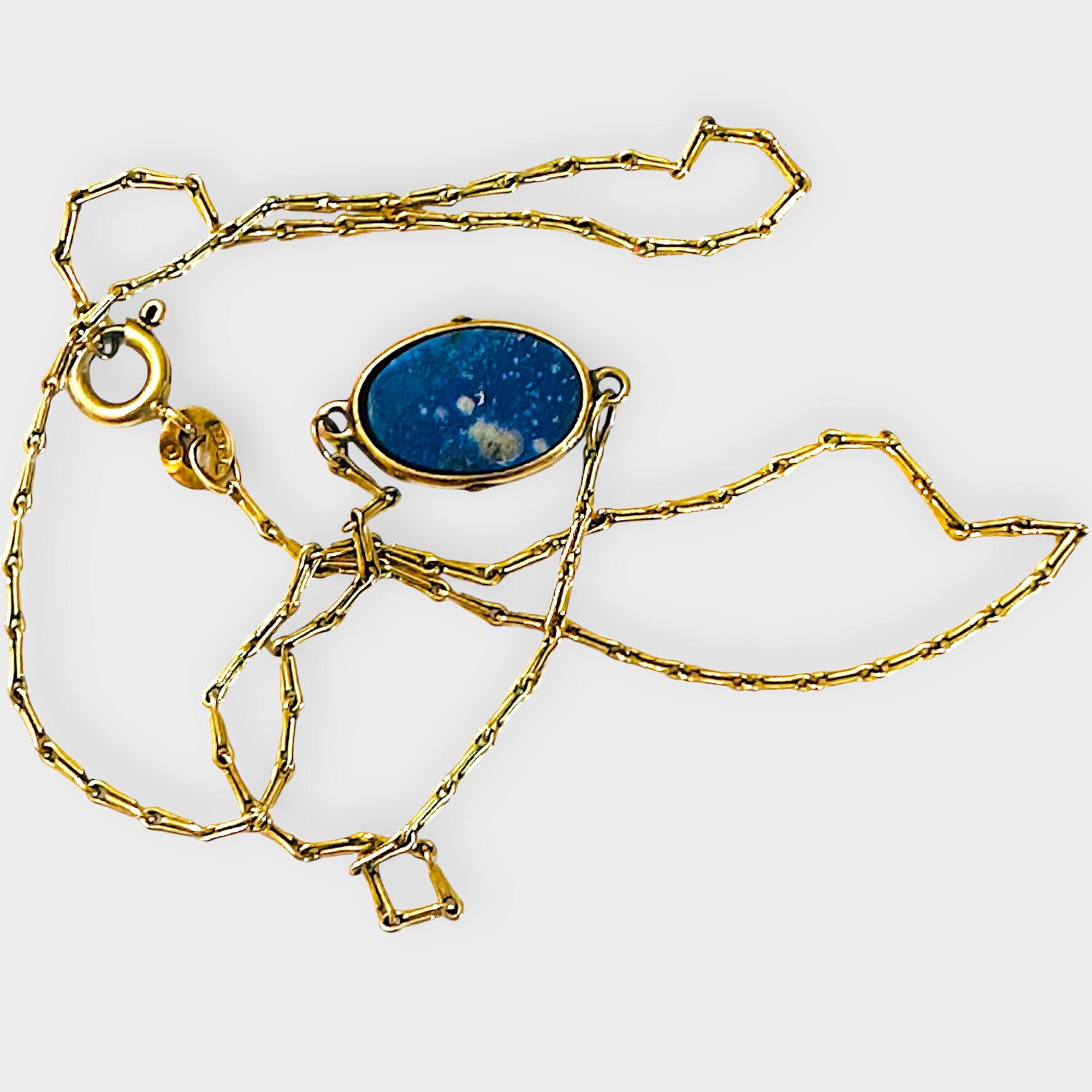 Vintage 9ct gold lapis lazuli pendant necklace on grey background
