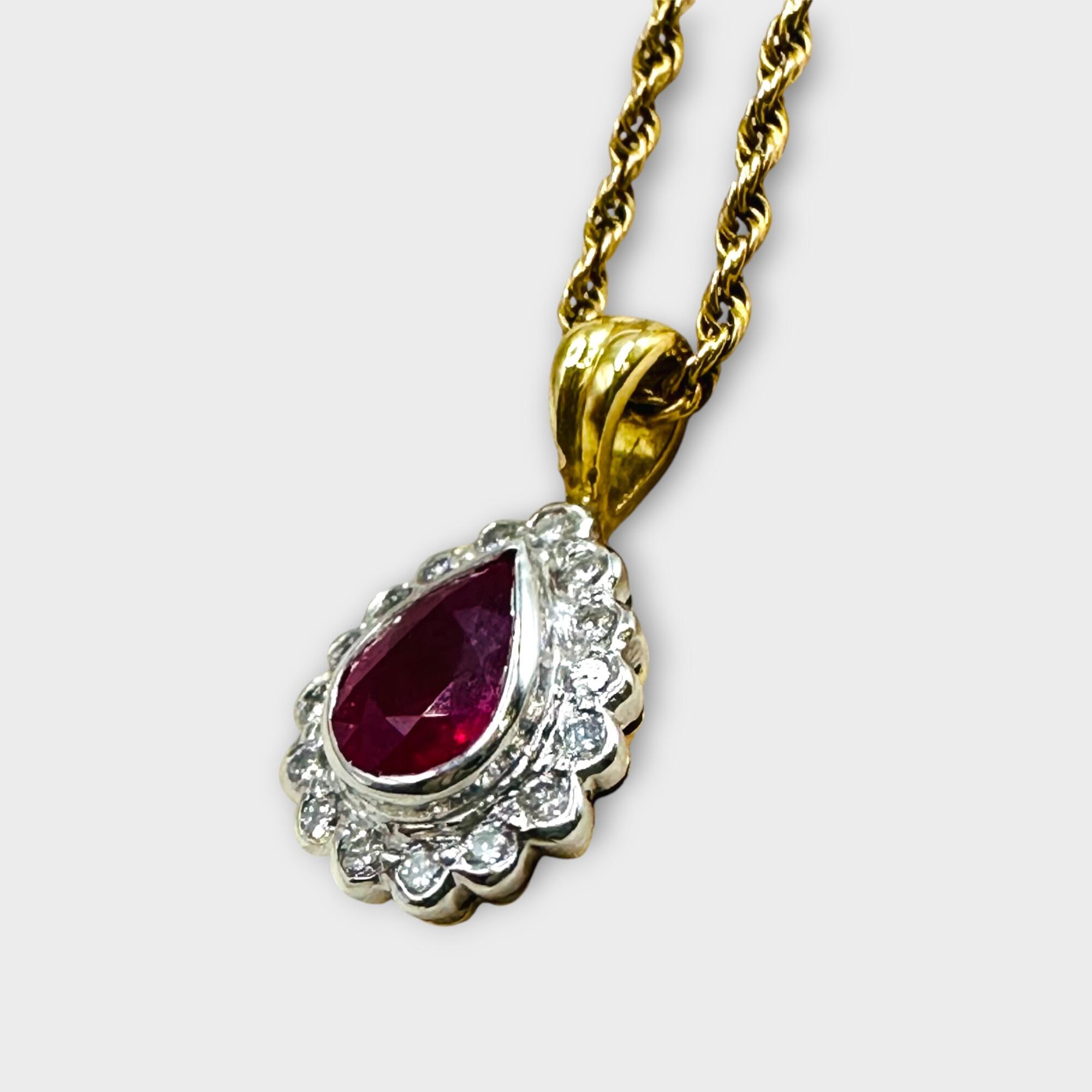 side view, 18k gold diamond and ruby pear shaped cluster pendant with grey background