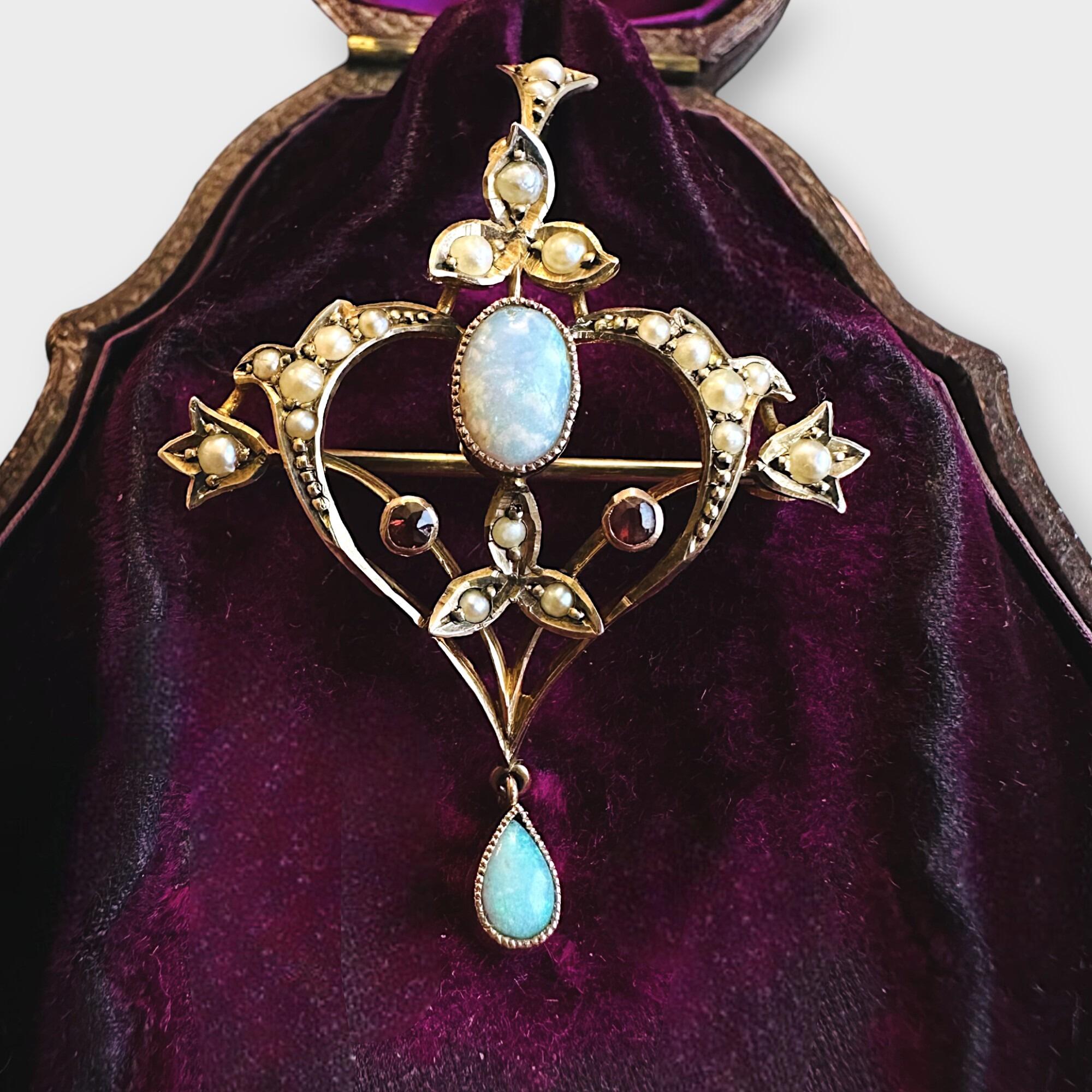 Art Nouveau 9k gold pendant brooch with openwork heart design, oval opal center, pearls, rubies, and fleur-de-lys bail
