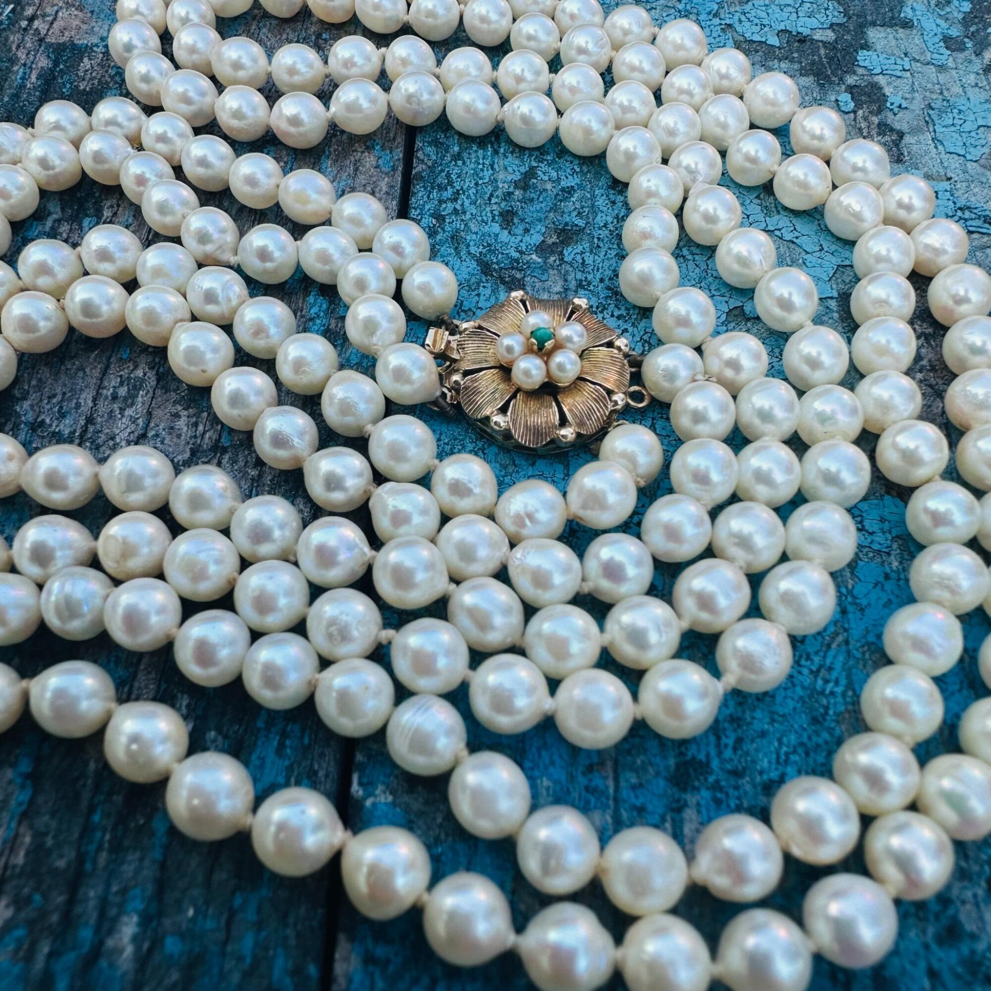 Cultured Pearl & Turquoise Necklace laying on textured surface.