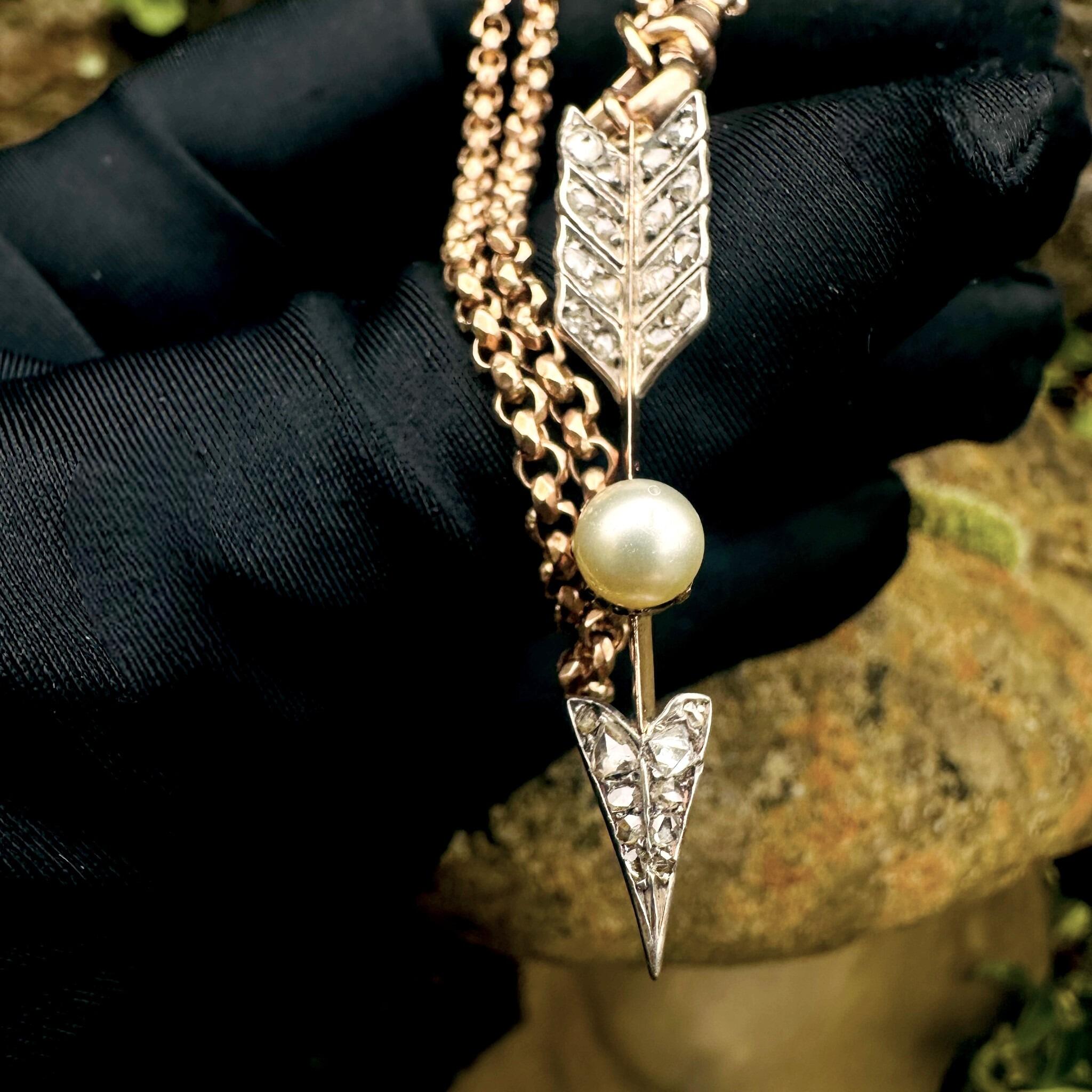 Victorian Rose Cut Diamond & Pearl Cupid’s Arrow Pendant held in gloved hand