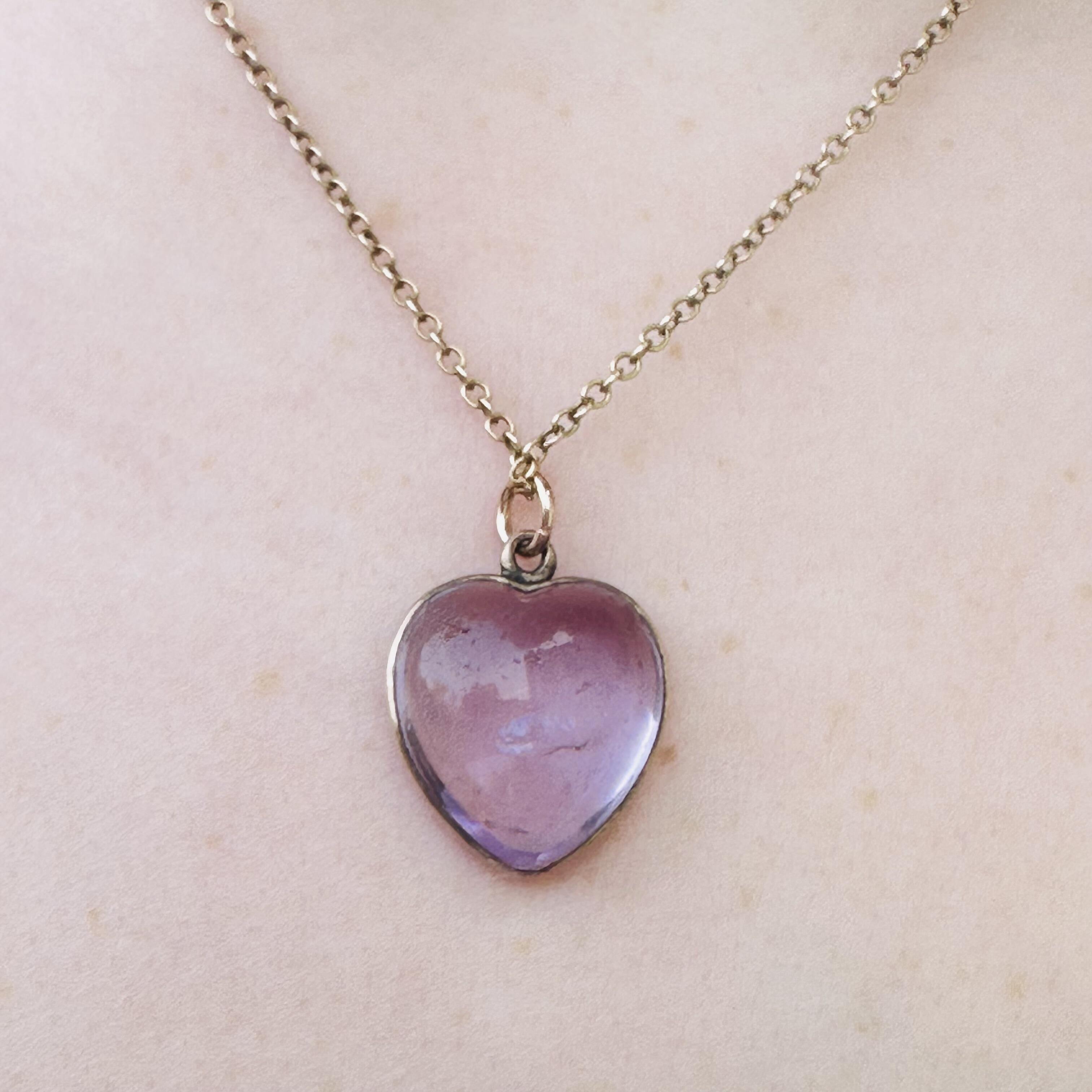 close up of Rose de France Amethyst Heart Pendant & Gold rolo link chain worn on models neck