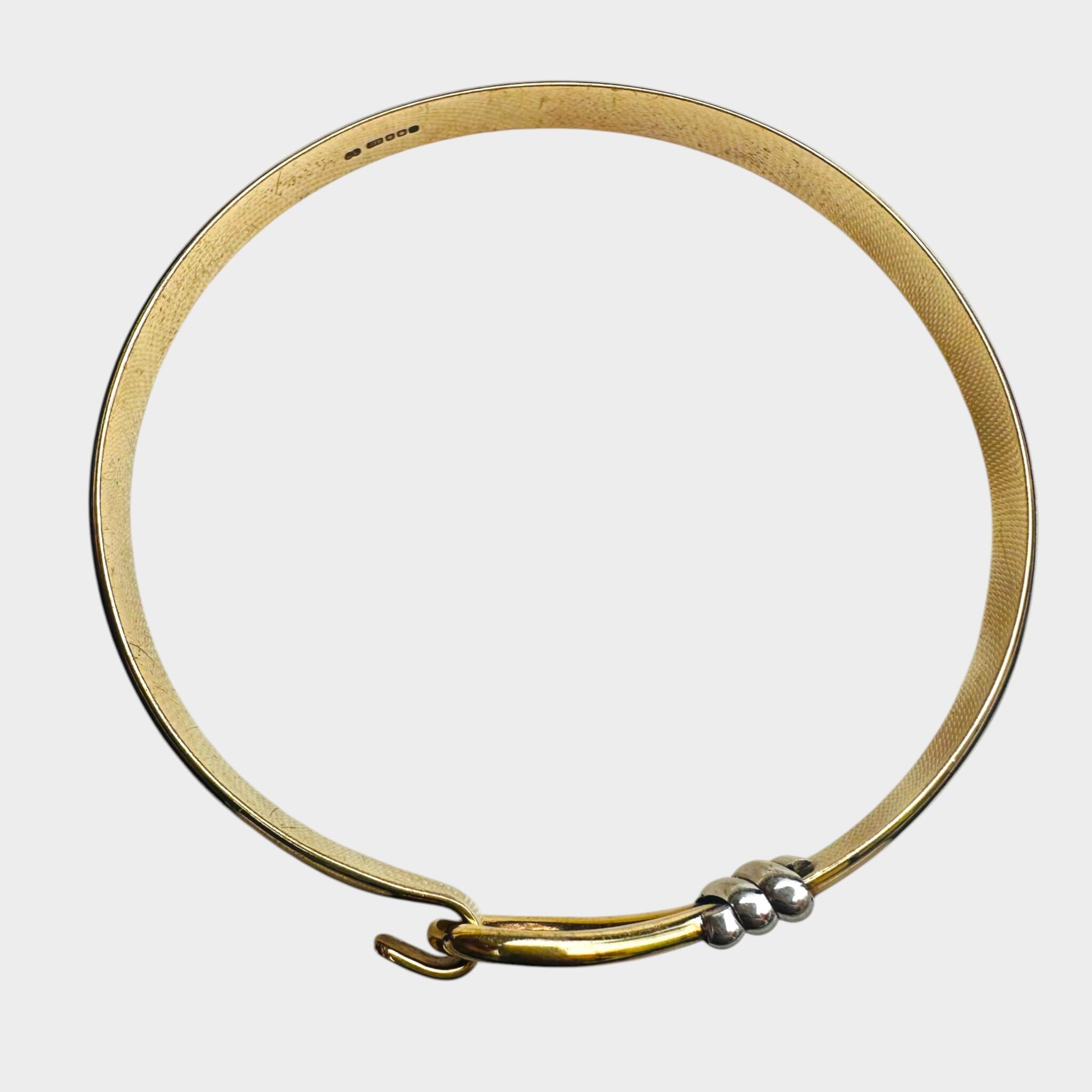 side profile of Vintage Two Tone Gold Bangle Bracelet with grey background