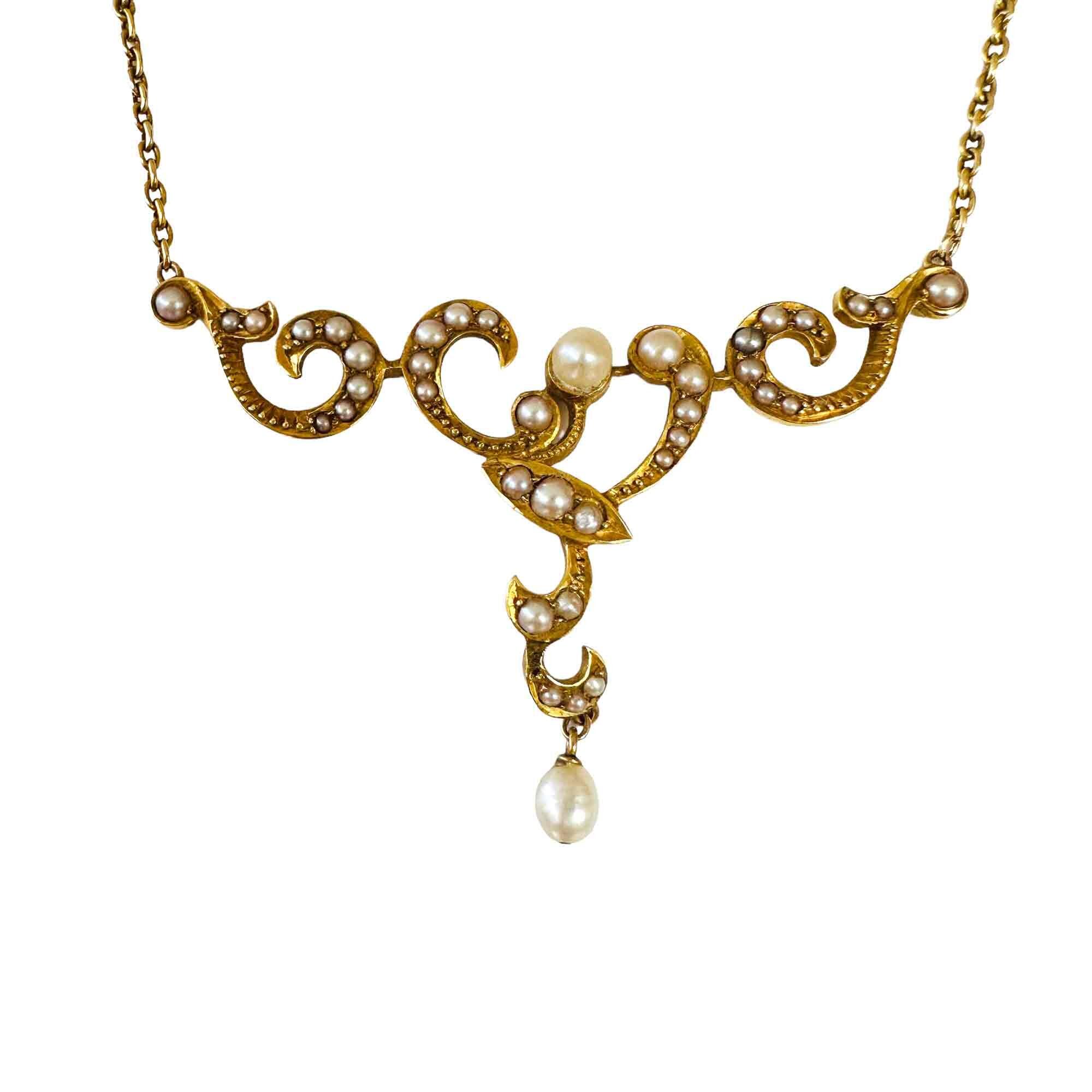 Victorian yellow gold T shaped lavalier pendant with seed pearls with white background