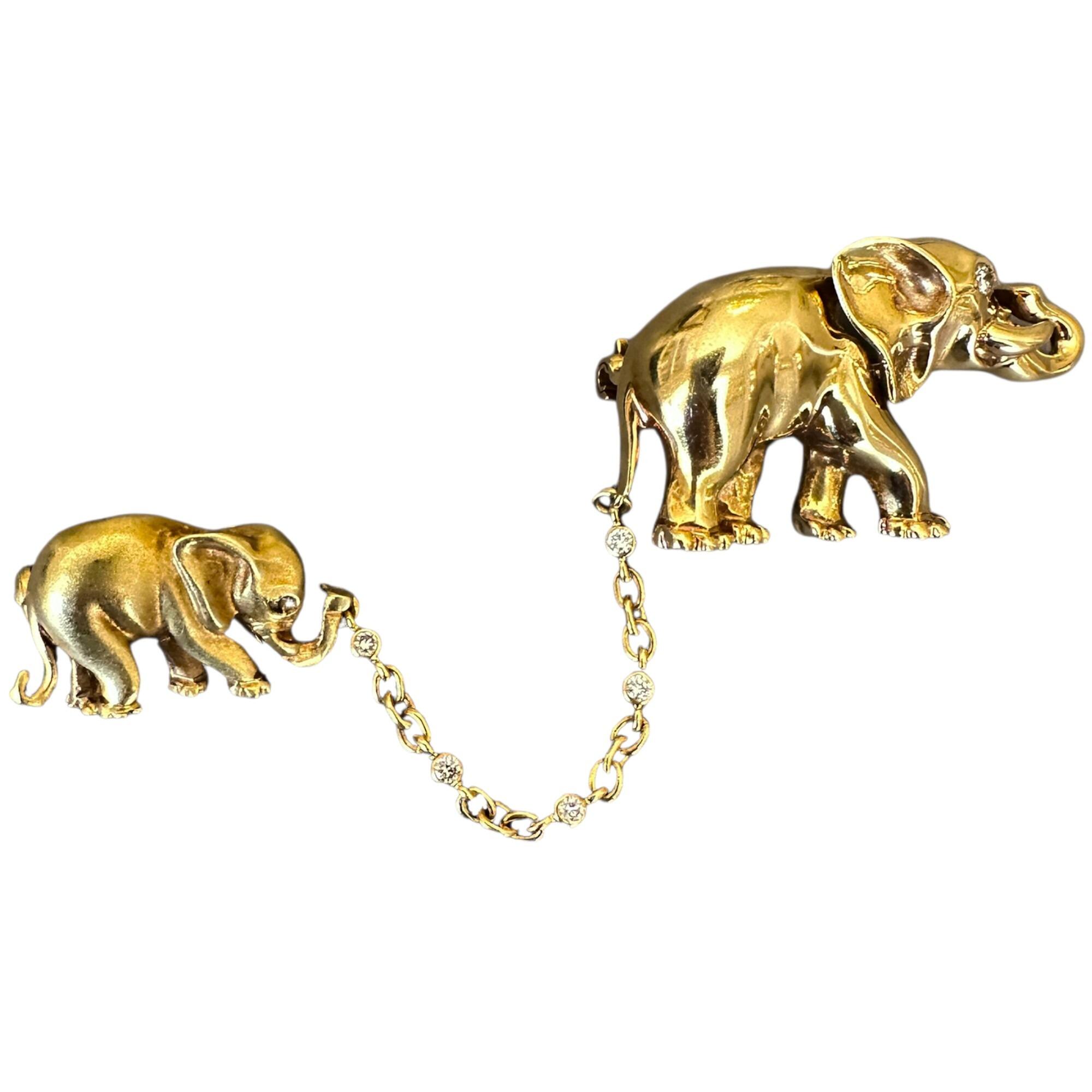 18k gold mother and baby elephant brooches connected with chain and diamond accents