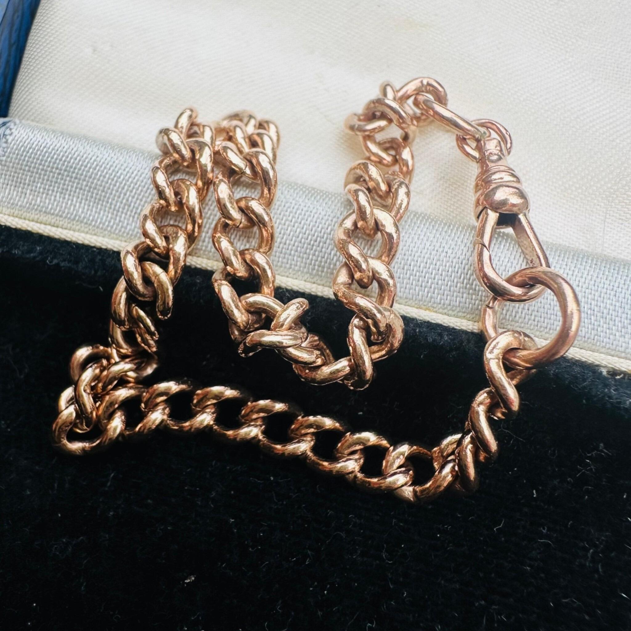 Antique Rose Gold Curb Link & Dog Clip Bracelet laying on antique box