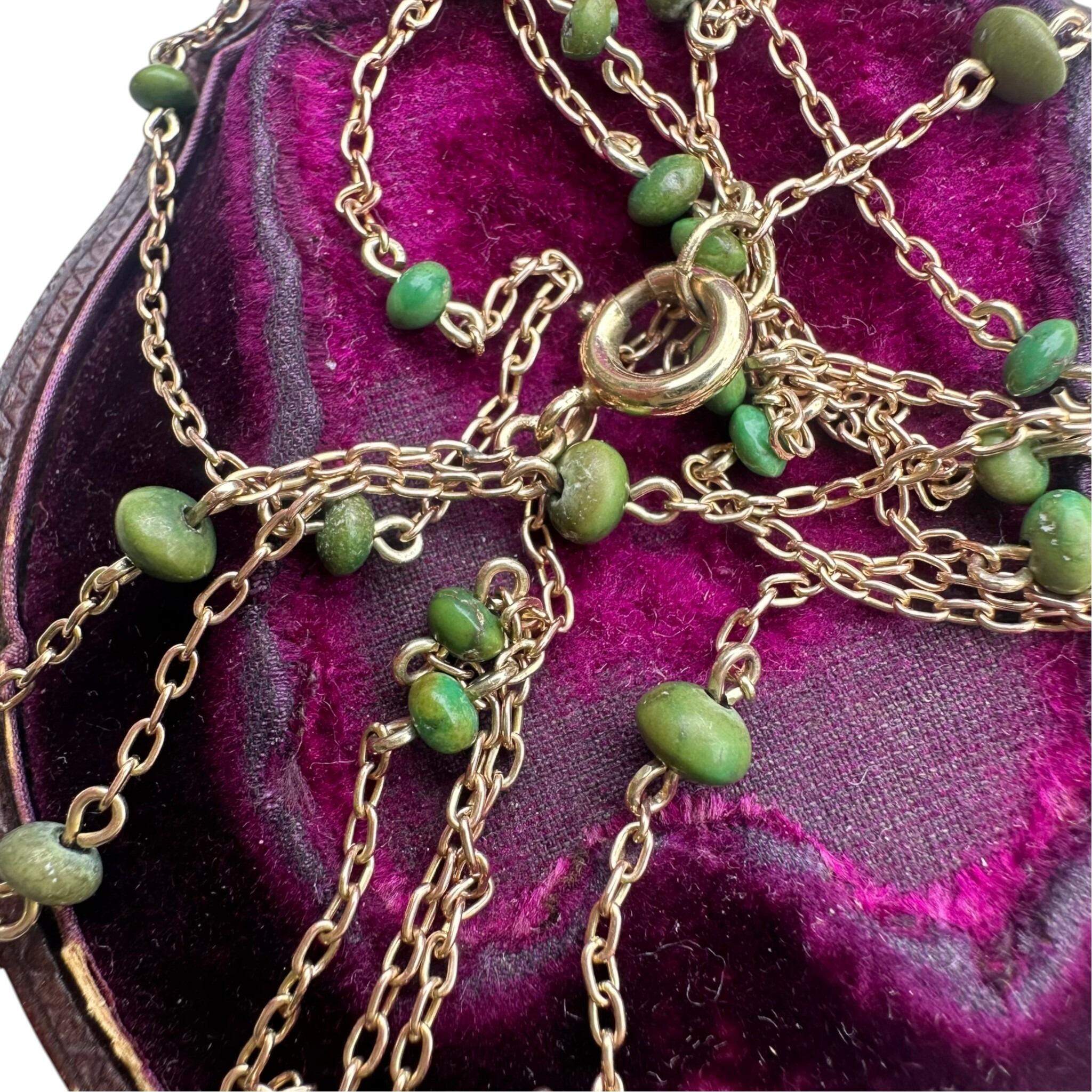 Antique Edwardian 9ct Rose Gold Turquoise Bead Guard Chain displayed on antique box with white background