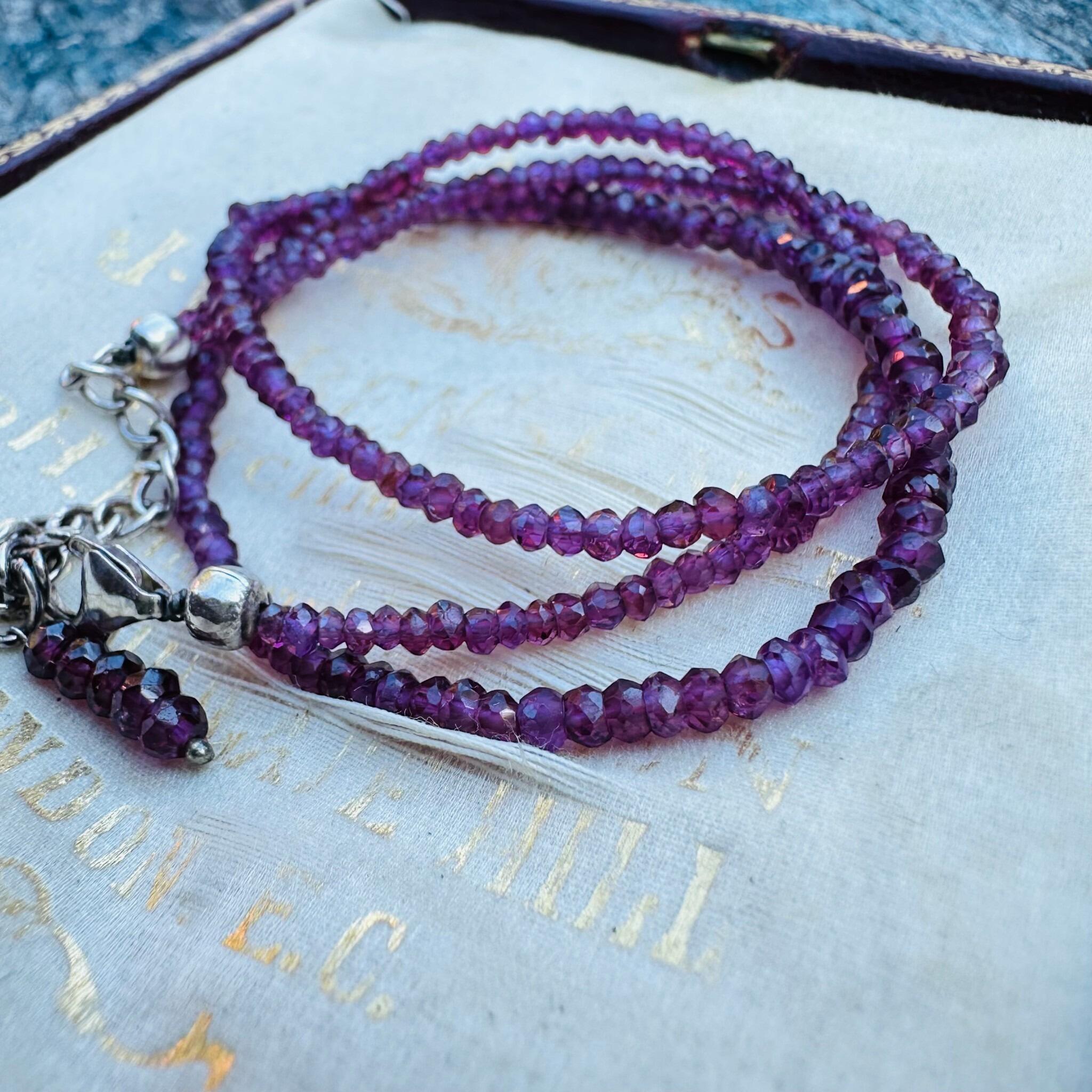 Silver & Amethyst Bead Necklace displayed on antique box