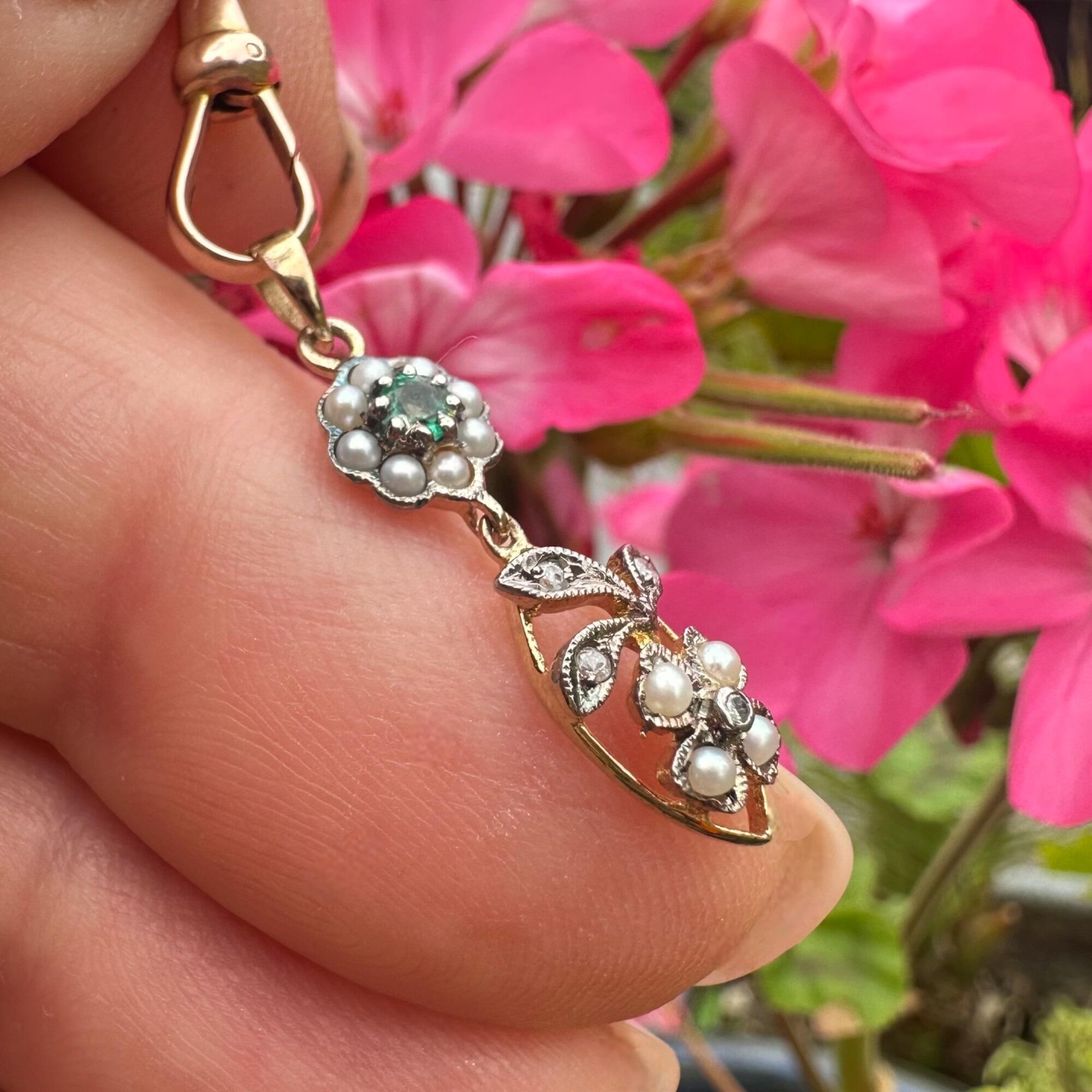 close up, Edwardian Style Emerald, Pearl & Diamond Pendant in Silver & 9k Gold held in hand.
