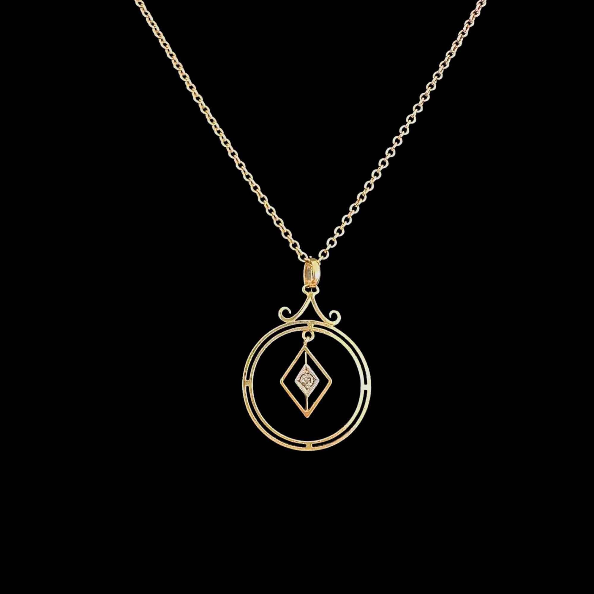 Front view of Art Deco 15k gold pendant with central diamond and geometric design.