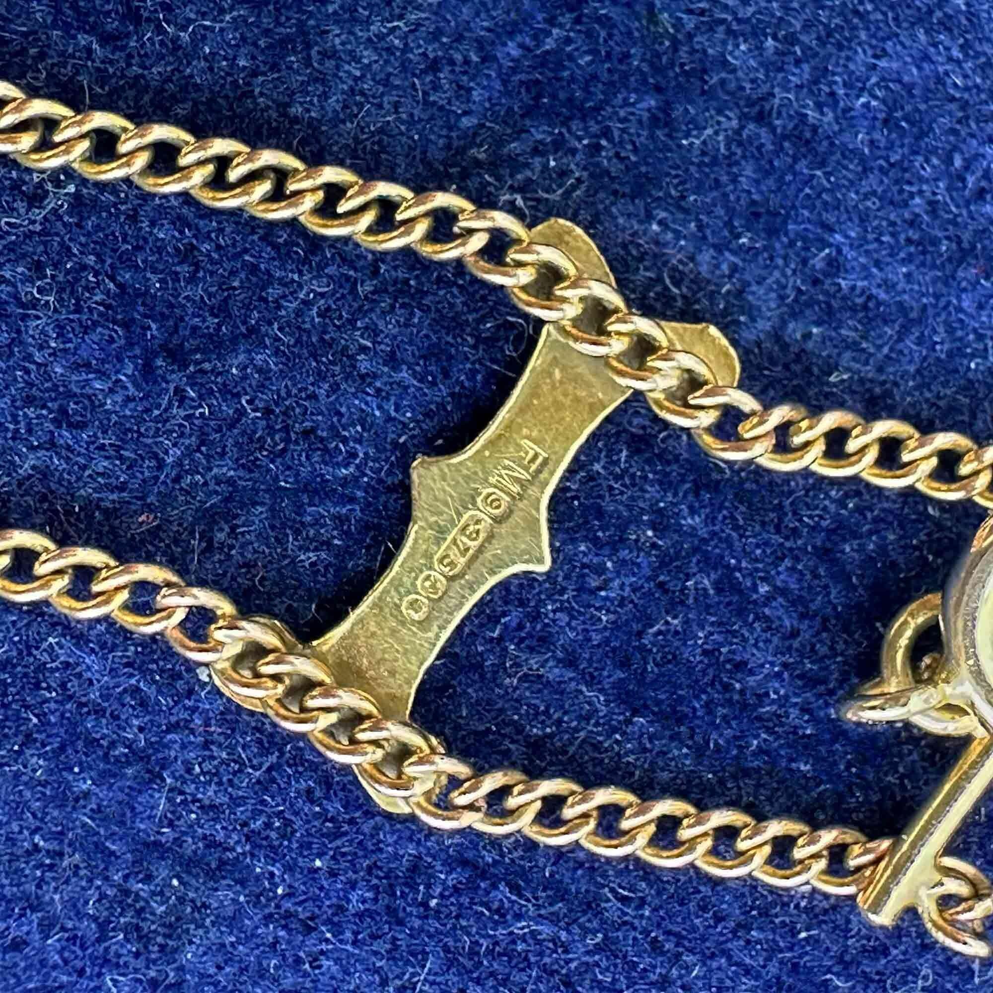 Close-up of London hallmark and 375 9ct gold stamp on bracelet