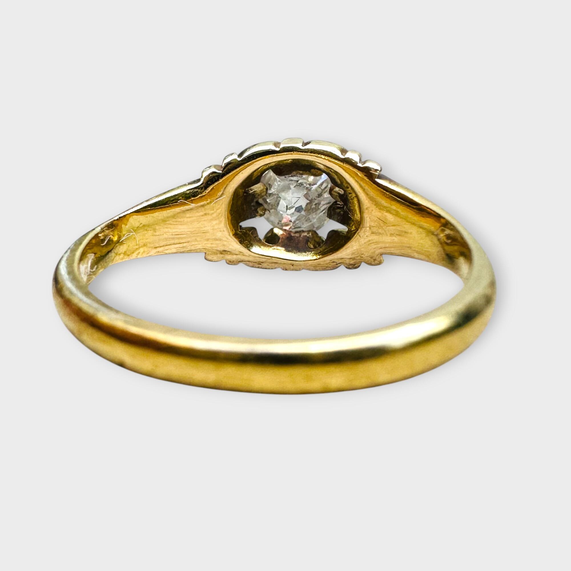 Rear view,Antique 18k yellow gold old cut diamond gypsy ring on grey background.