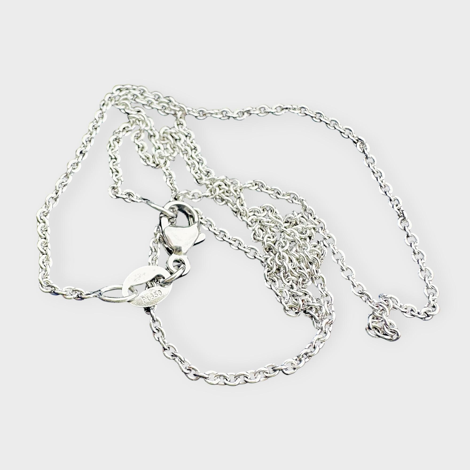 platinum rolo chain on grey background.
