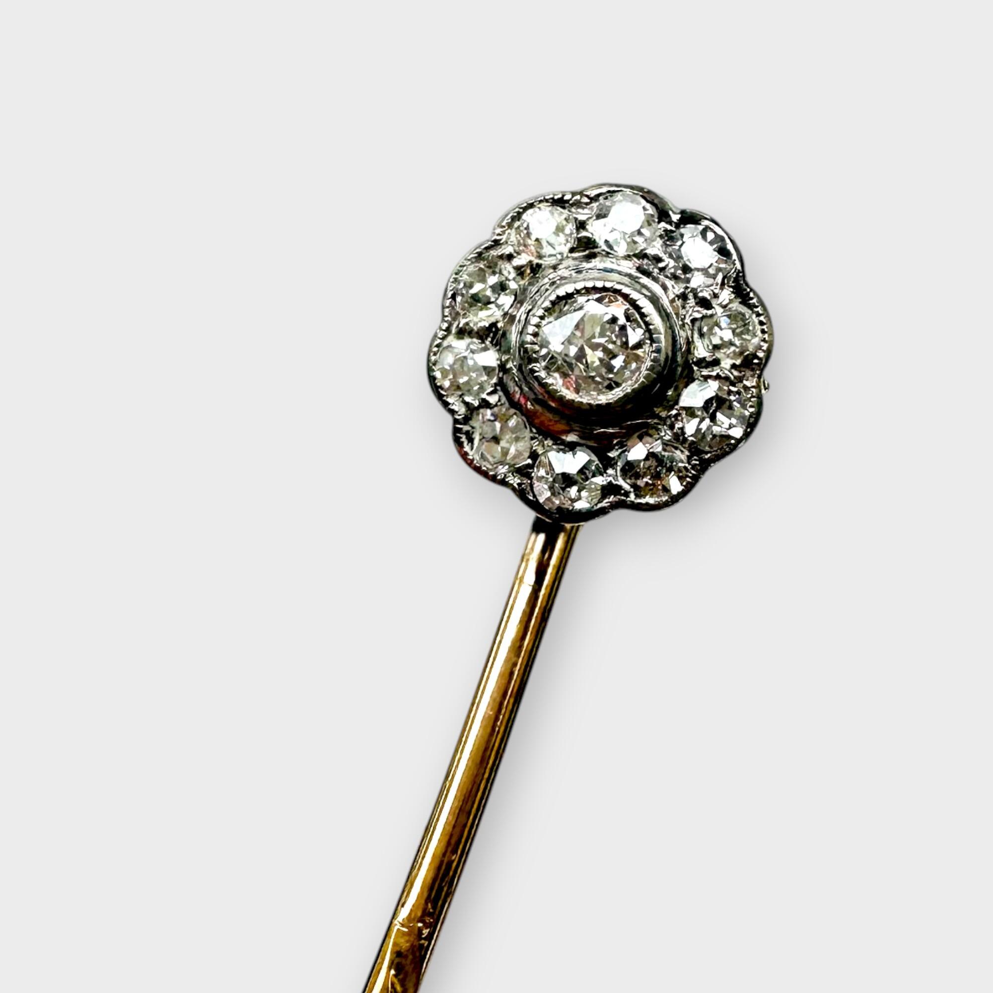 Antique diamond stick pin in antique box with grey background.