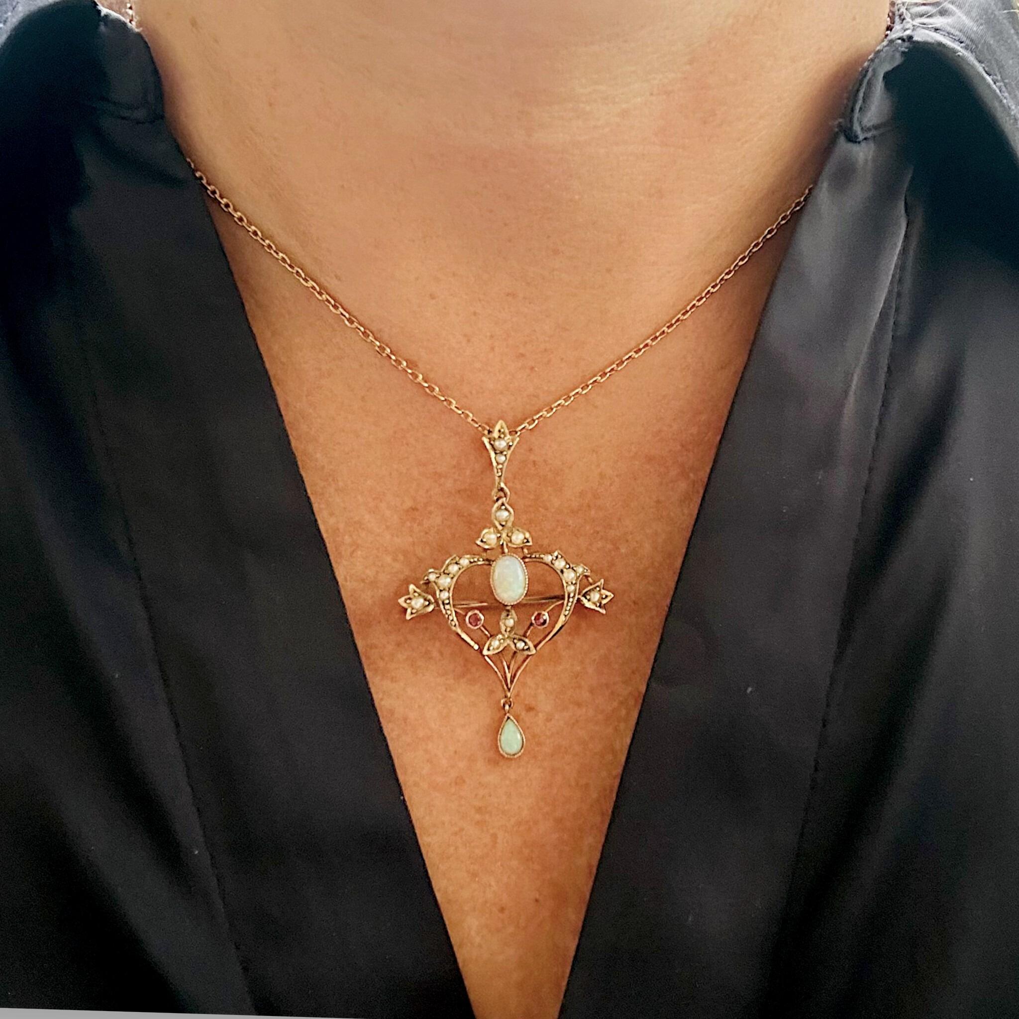 Antique 9k gold heart pendant worn on chain with opal, ruby, and pearl detailing