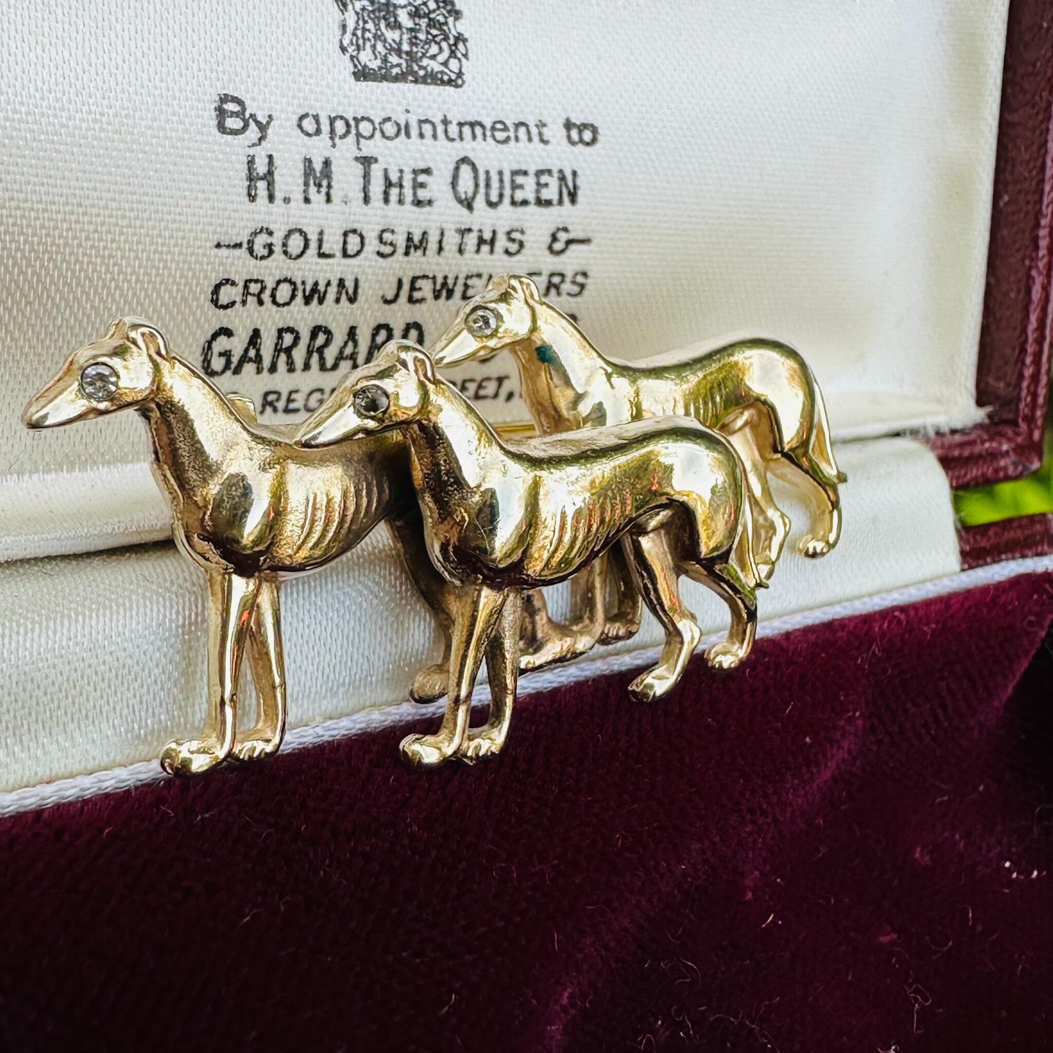 Rare, Antique 15k Gold Triple Greyhound Brooch with Diamond Eyes, displayed in antique box.
