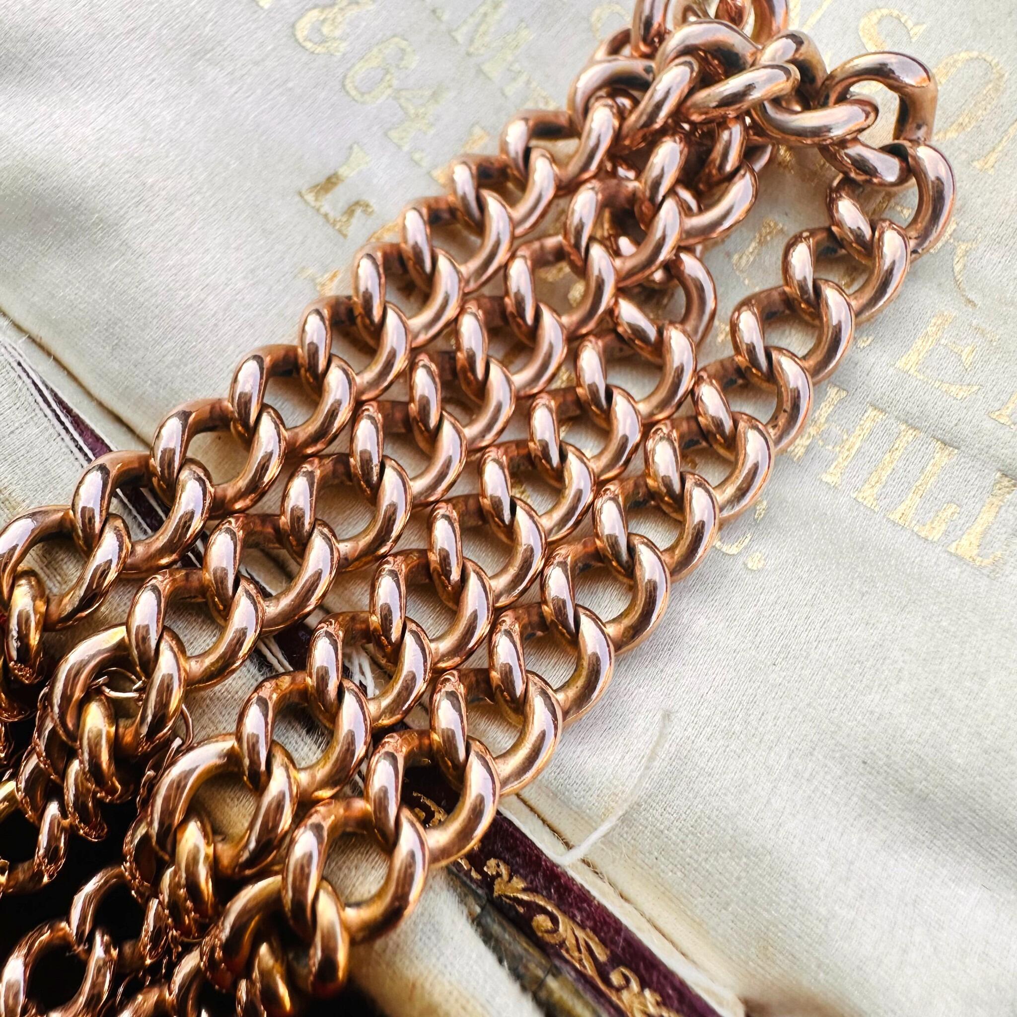 Rose Gold Double Curb Link Bracelet with Heart Padlock , displayed on antique box.