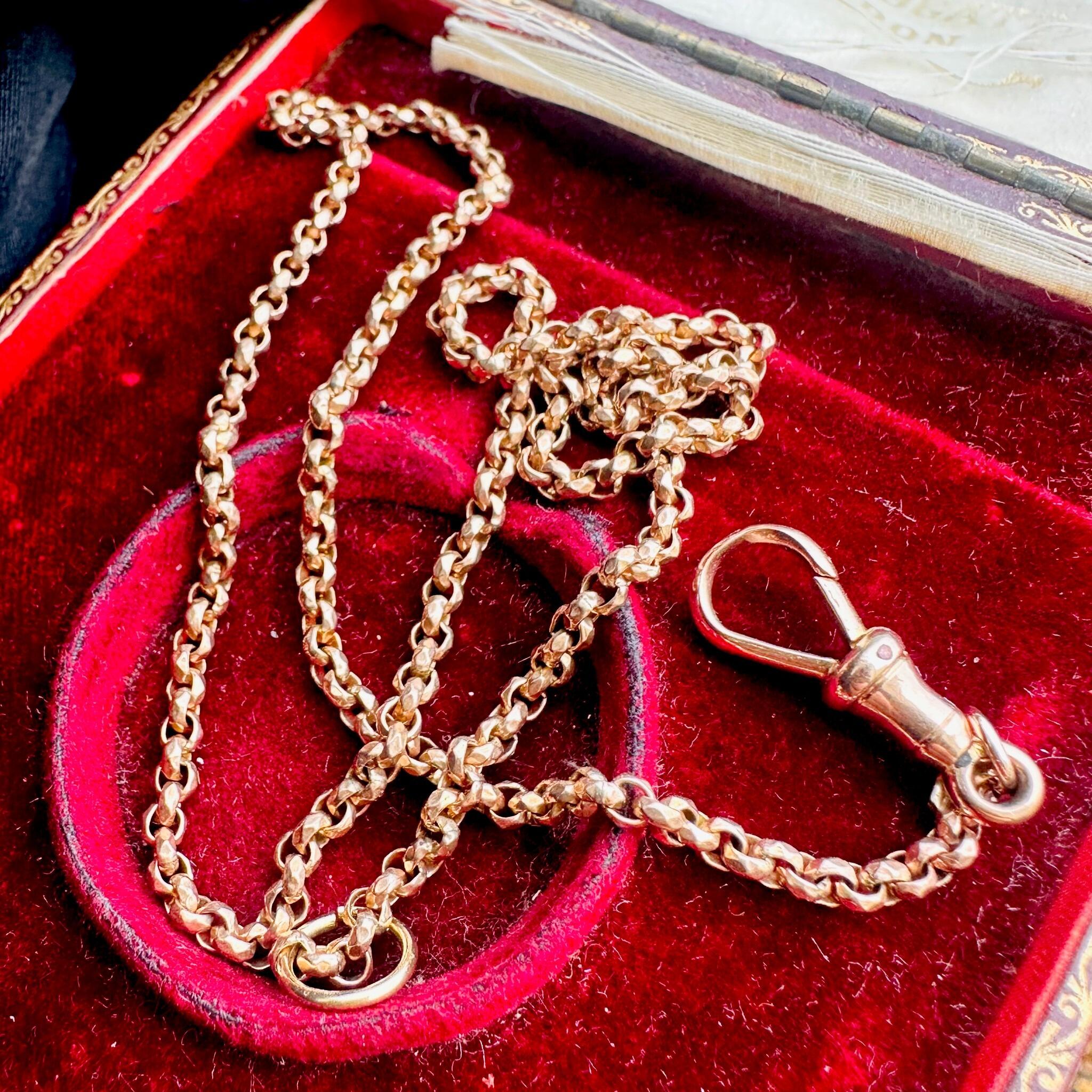 Rose Gold Faceted Belcher Chain with Dog Clip Clasp displayed on an antique box.