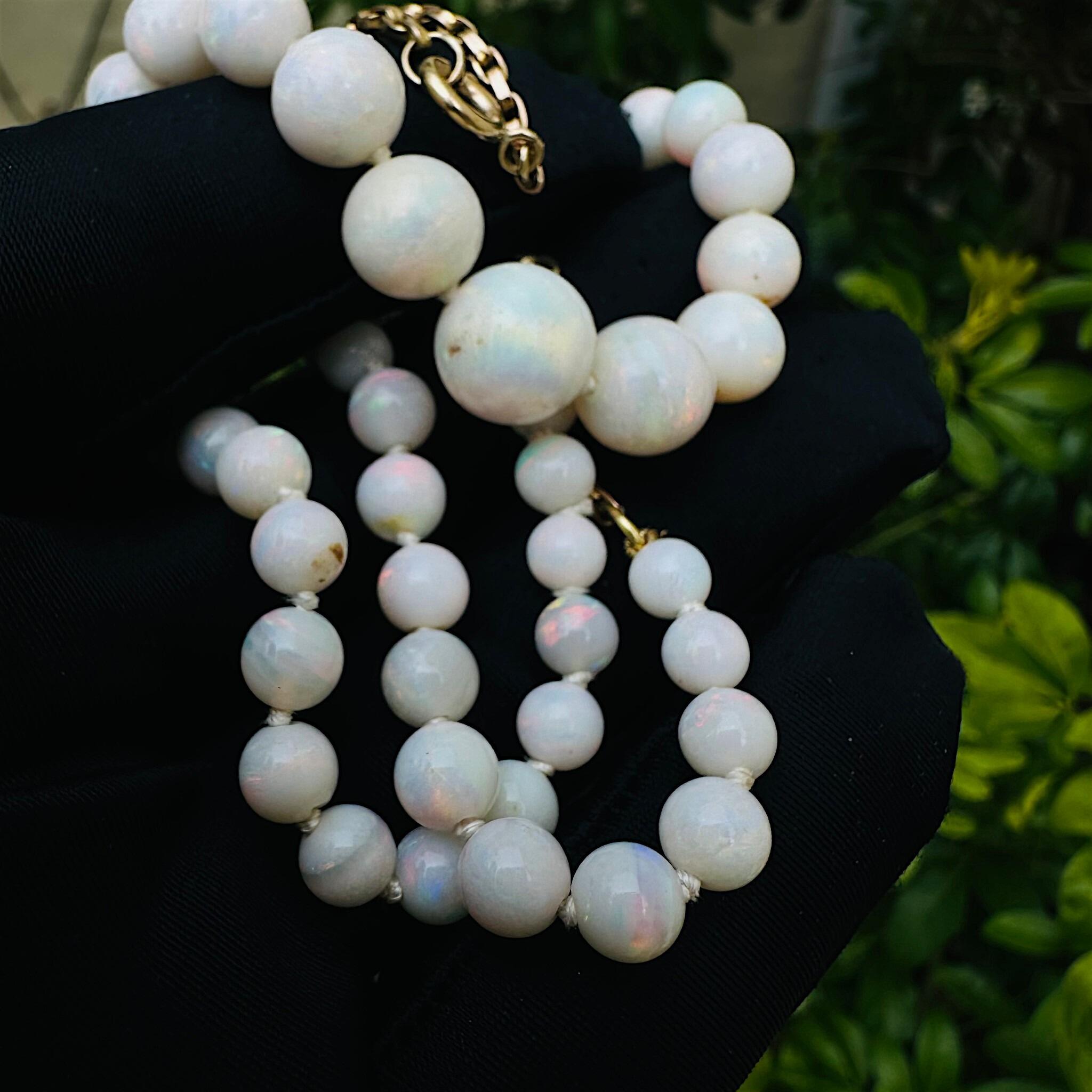 Art Deco Graduated Opal Bead & Gold Bike Chain Necklace held in black glove in garden