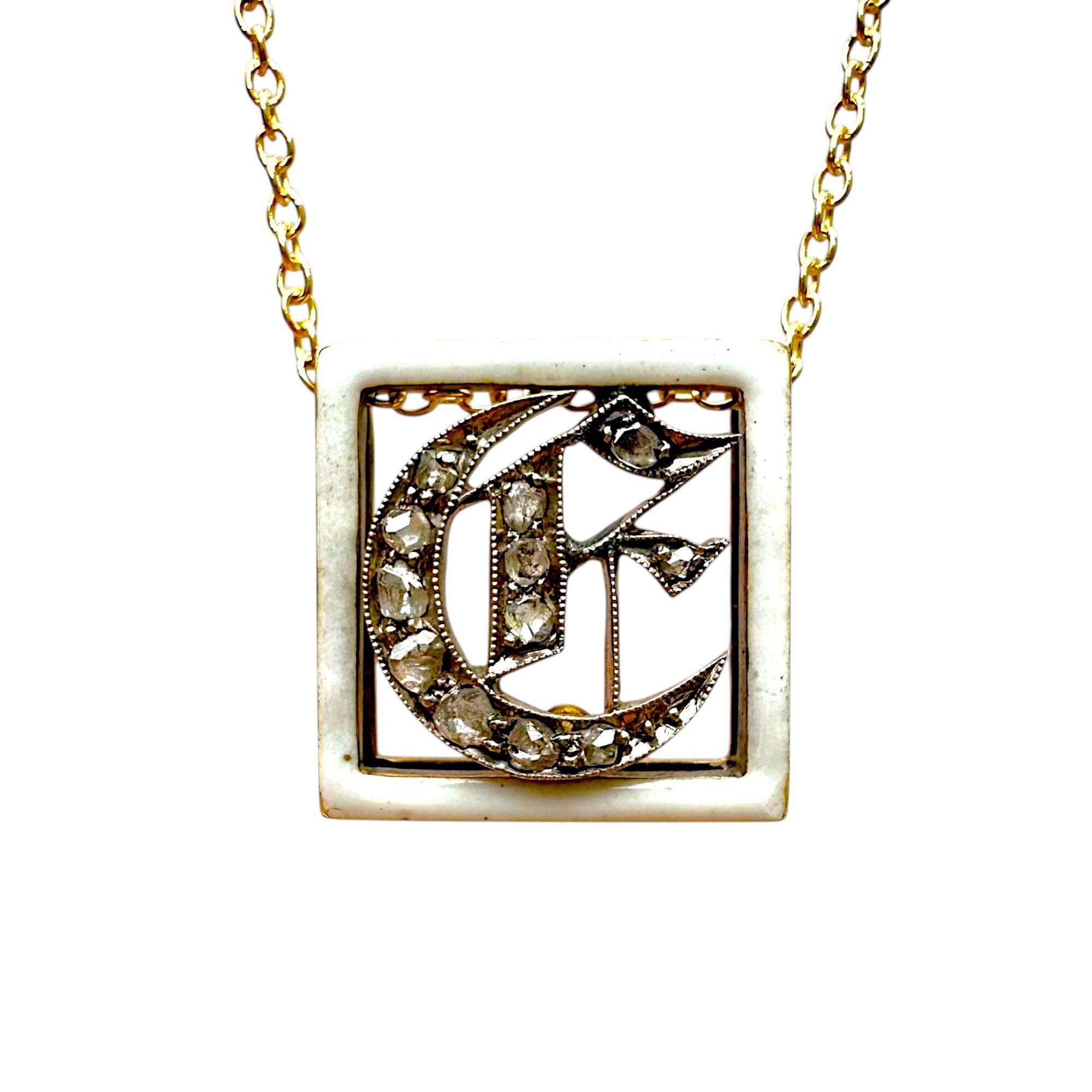 Victorian enamel and diamond monogram, initial buckle, slider pendant on white background.