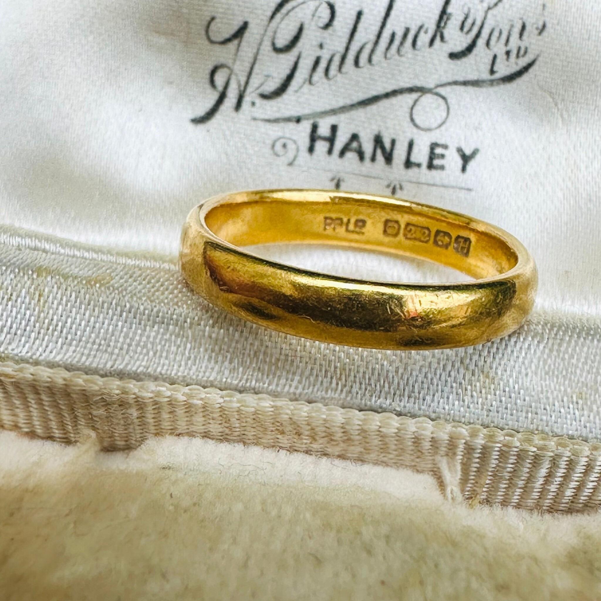 Vintage 22k Gold Wedding Band Ring displayed on antique box