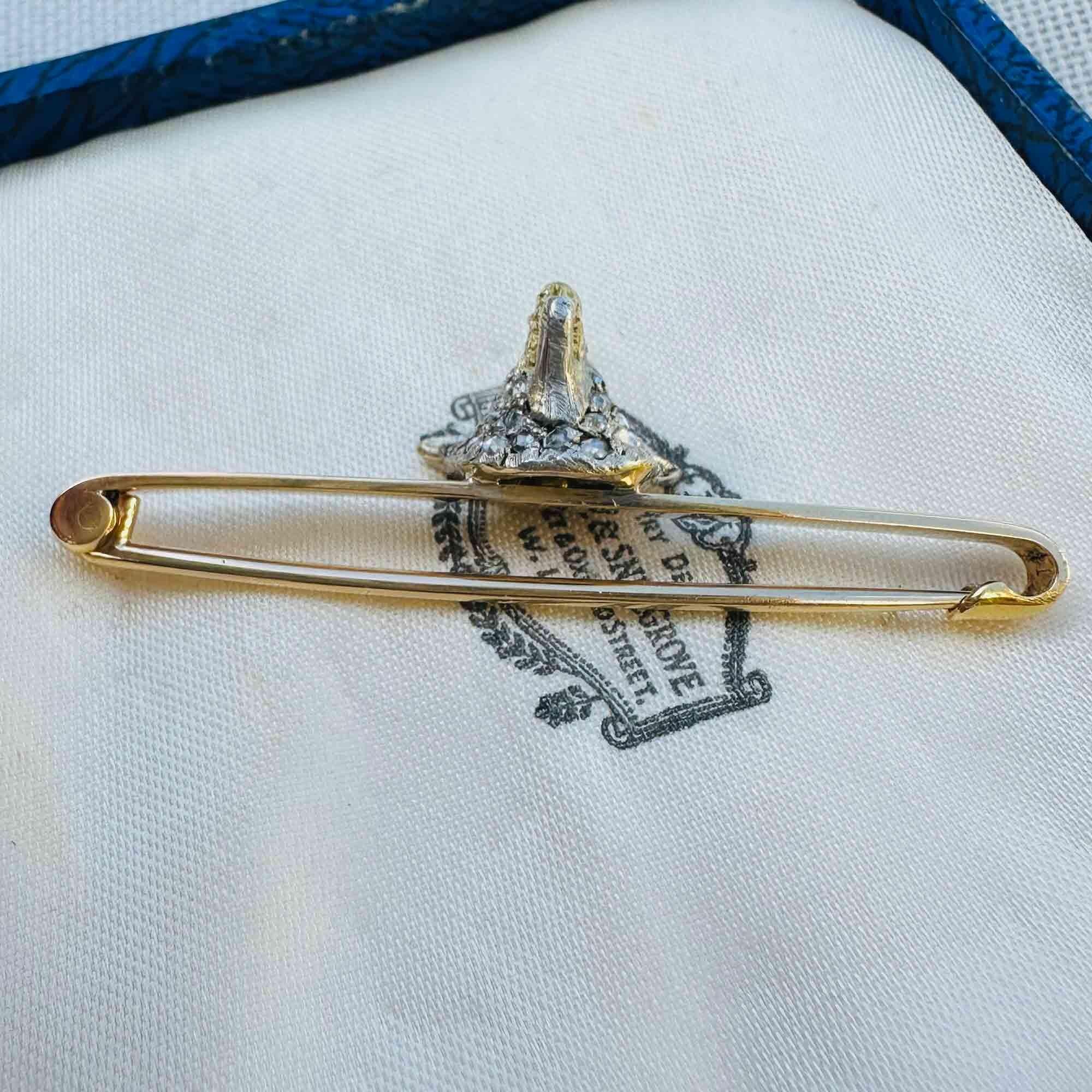 Side view of Antique diamond fox head brooch with rose cut diamonds, ruby eyes, and gold teeth detail