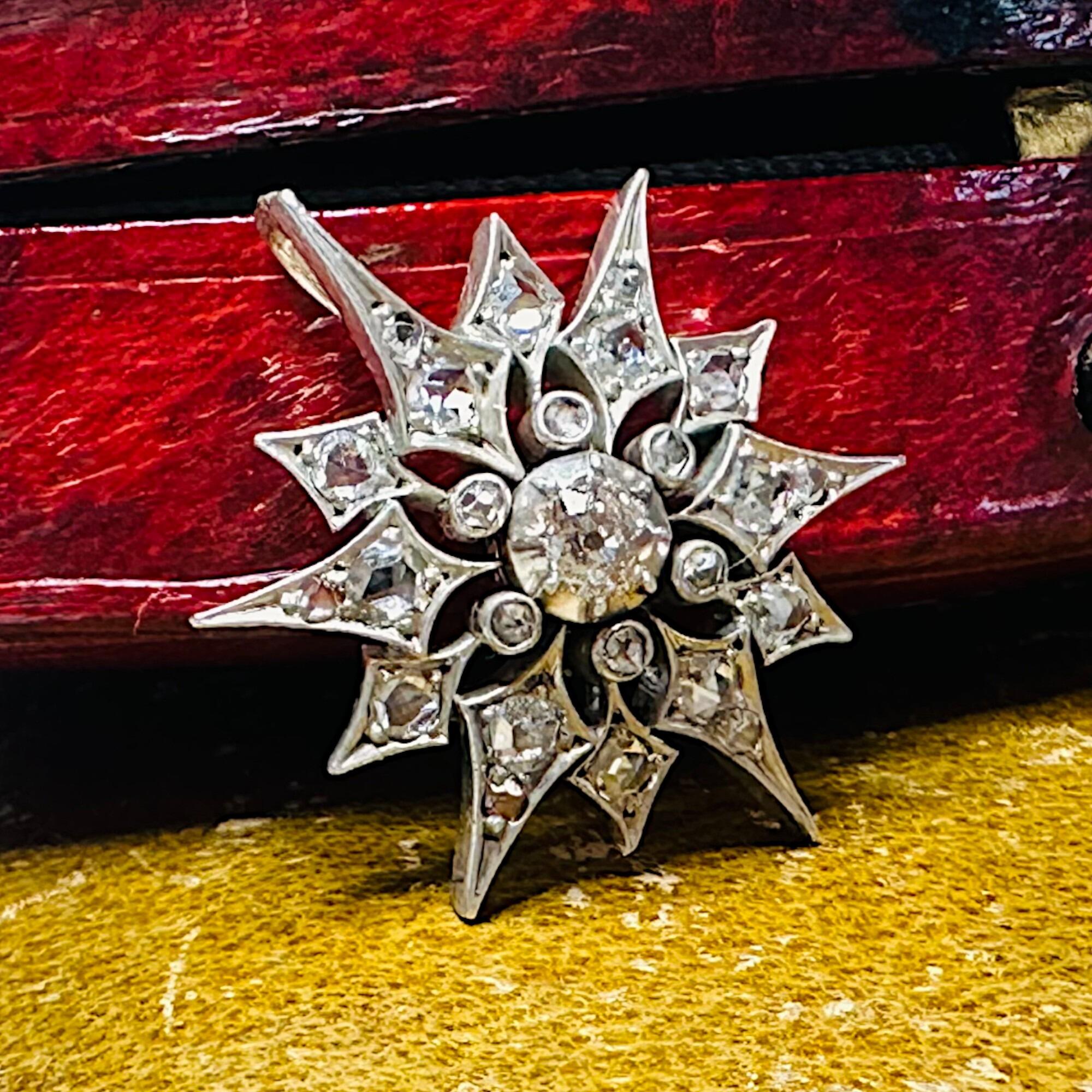 Victorian Diamond Star Pendant, Antique Silver & Rose Gold Starburst, displayed with a red textured antique box.