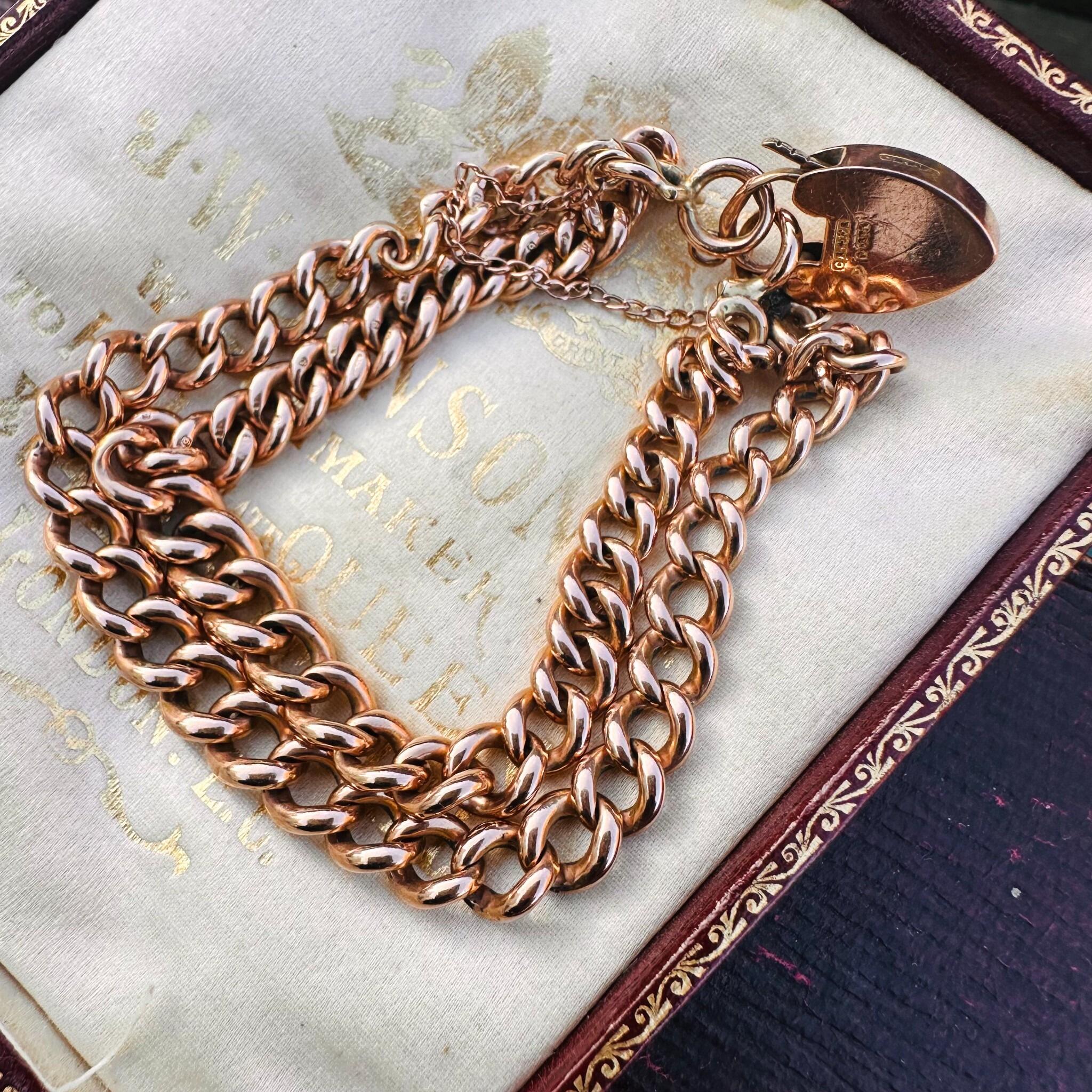 Rose Gold Double Curb Link Bracelet with Heart Padlock , displayed on antique box.