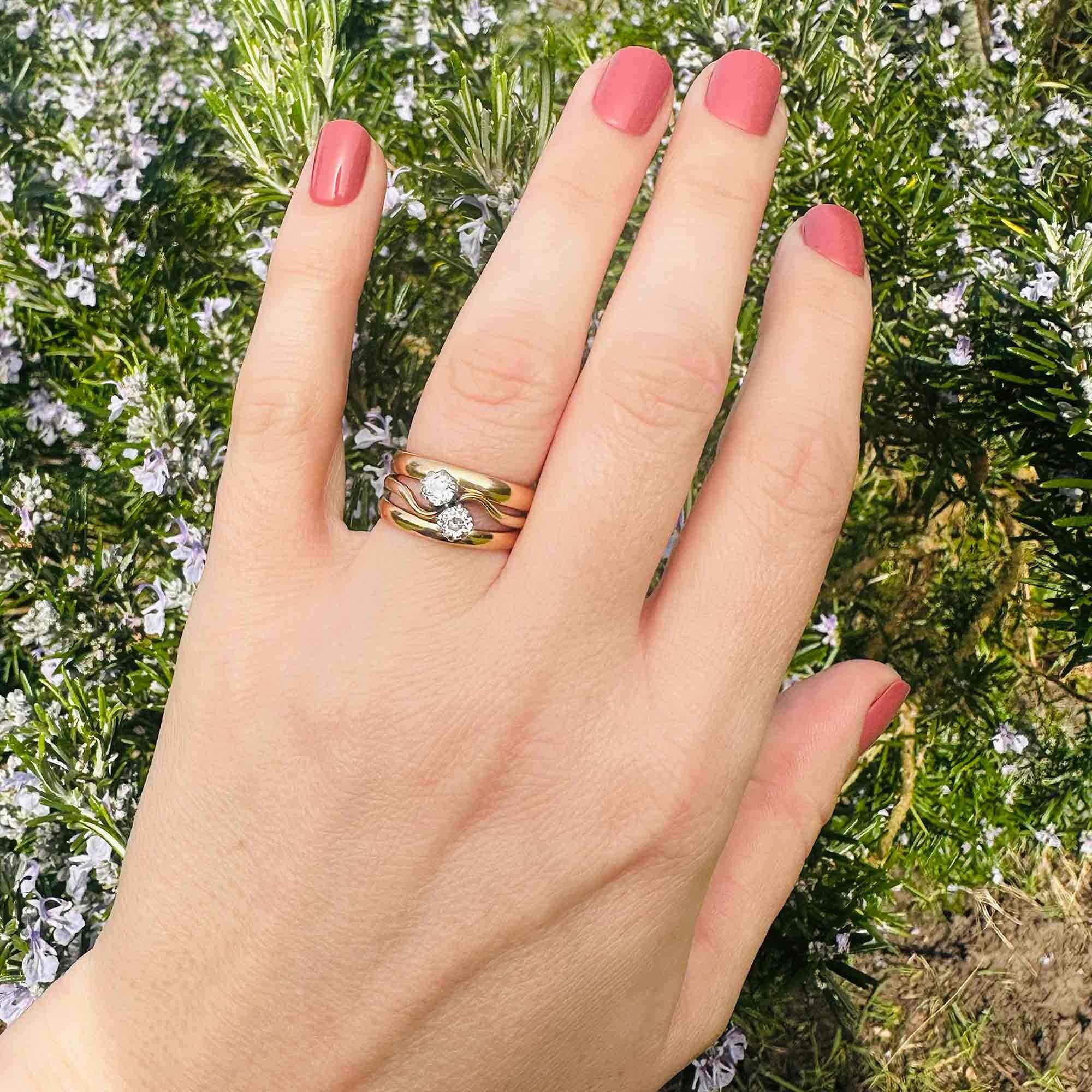 18ct Gold & Diamond Toi et Moi Ring worn on models hand in garden